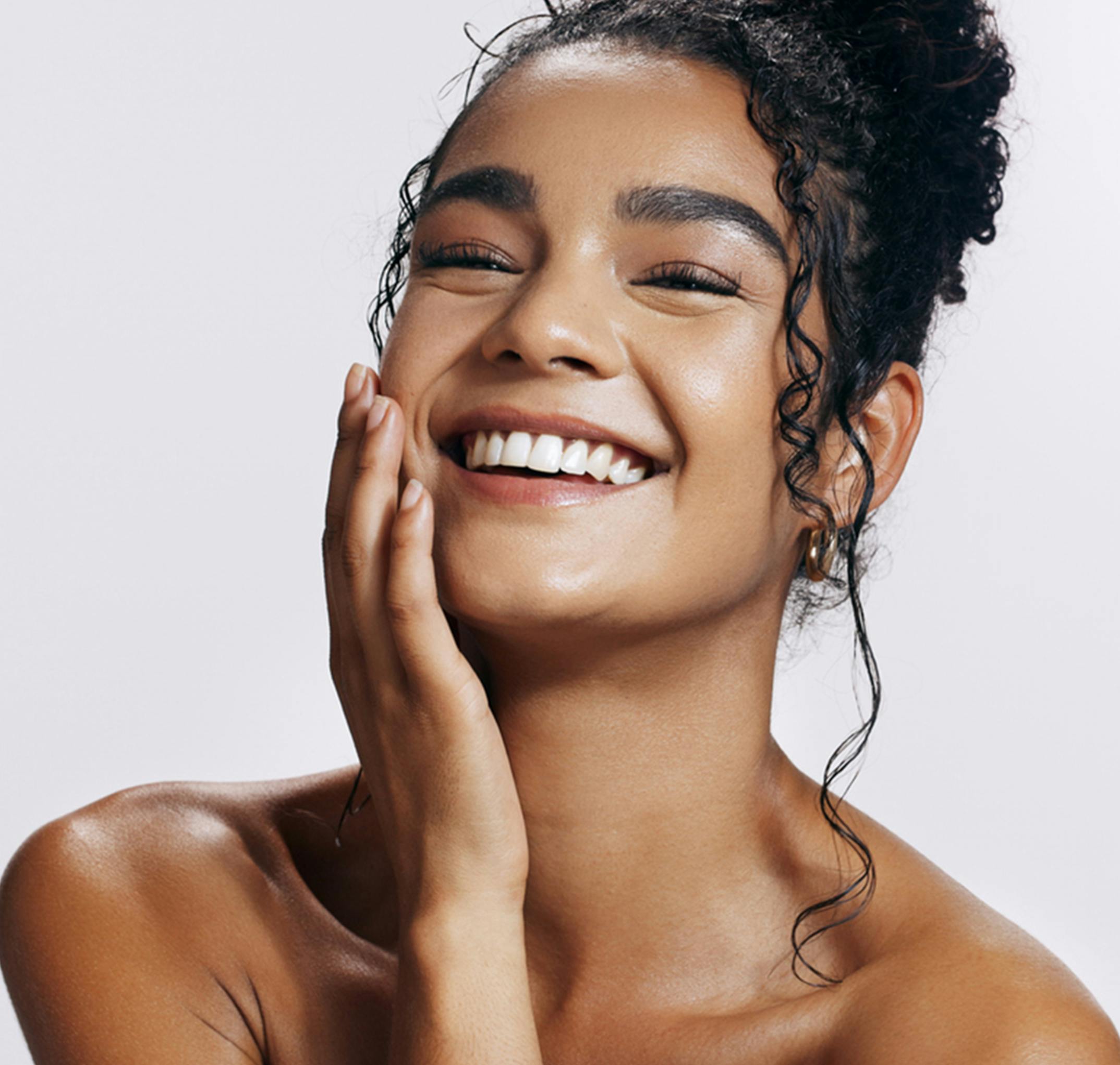 smiling woman touching her face