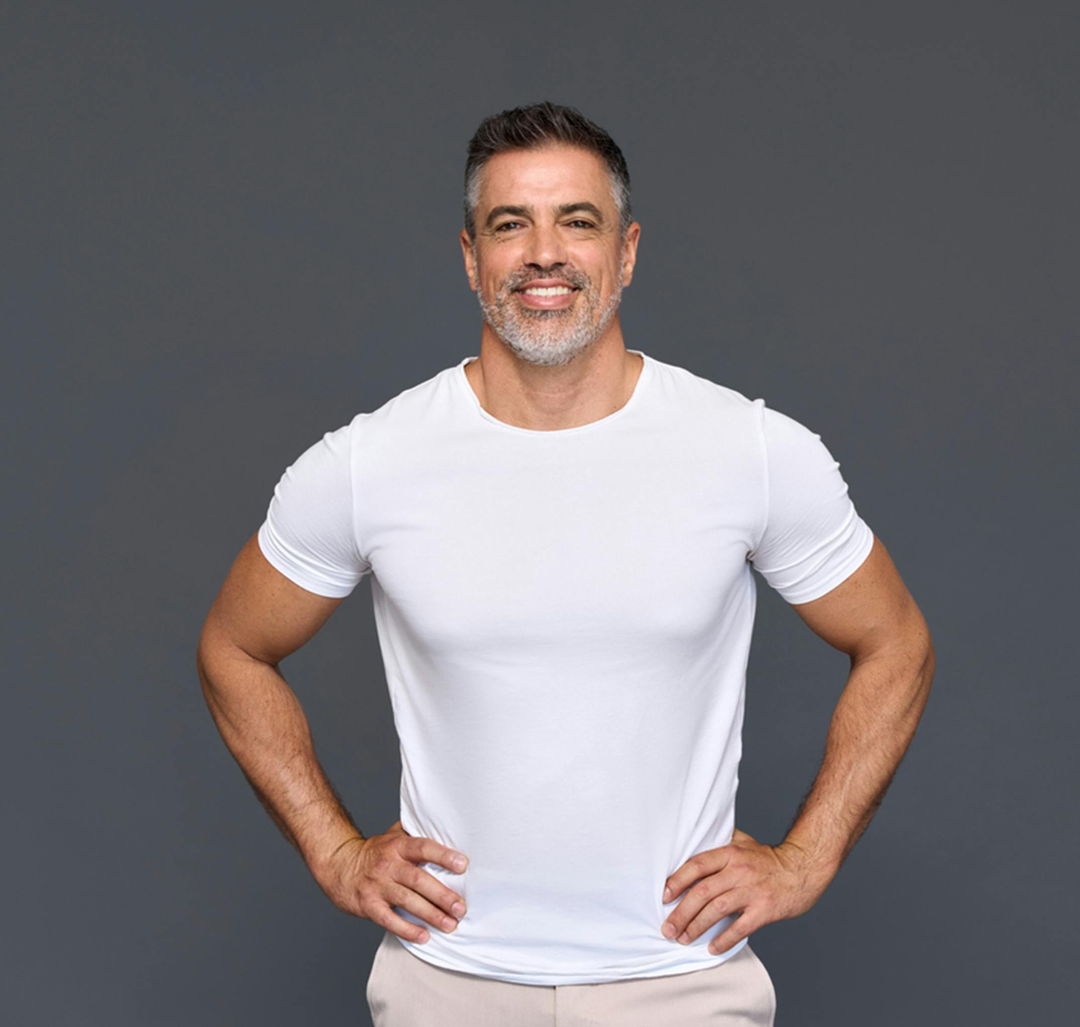 man standing with his hands on his hips