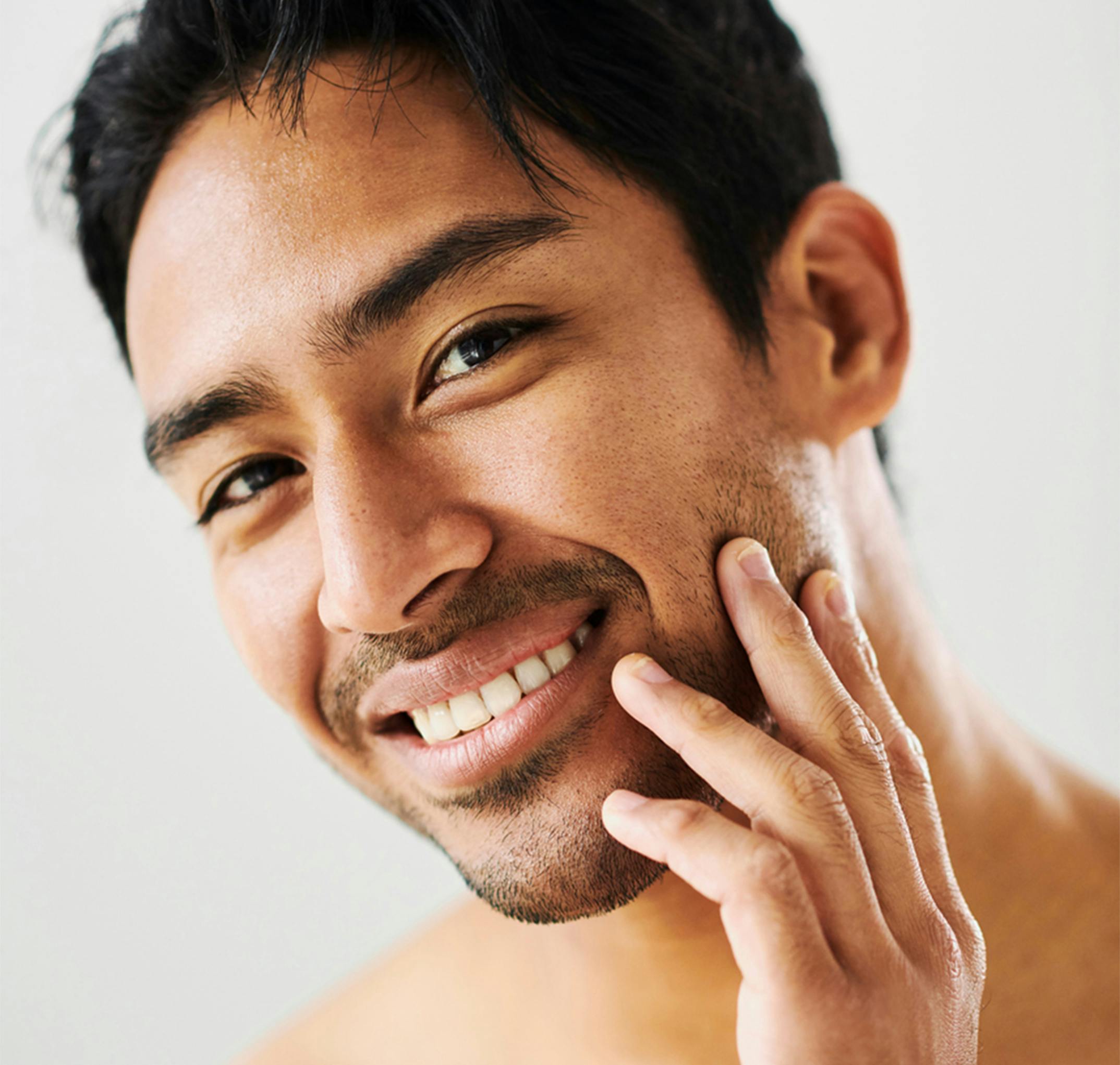 man touching his cheek