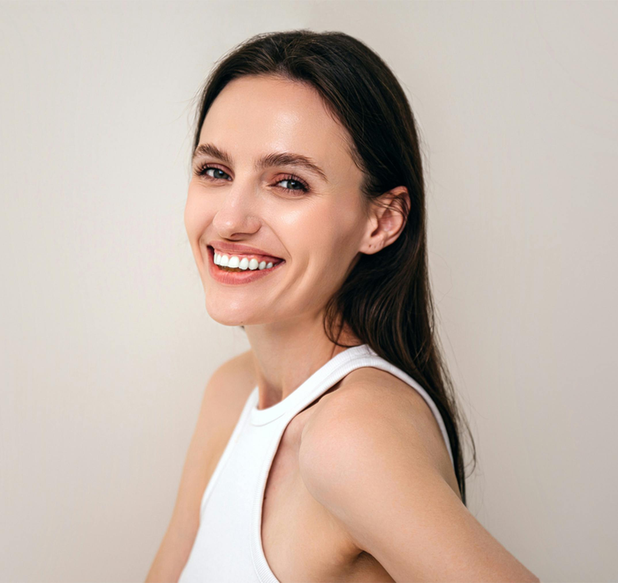 woman smiling over her shoulder
