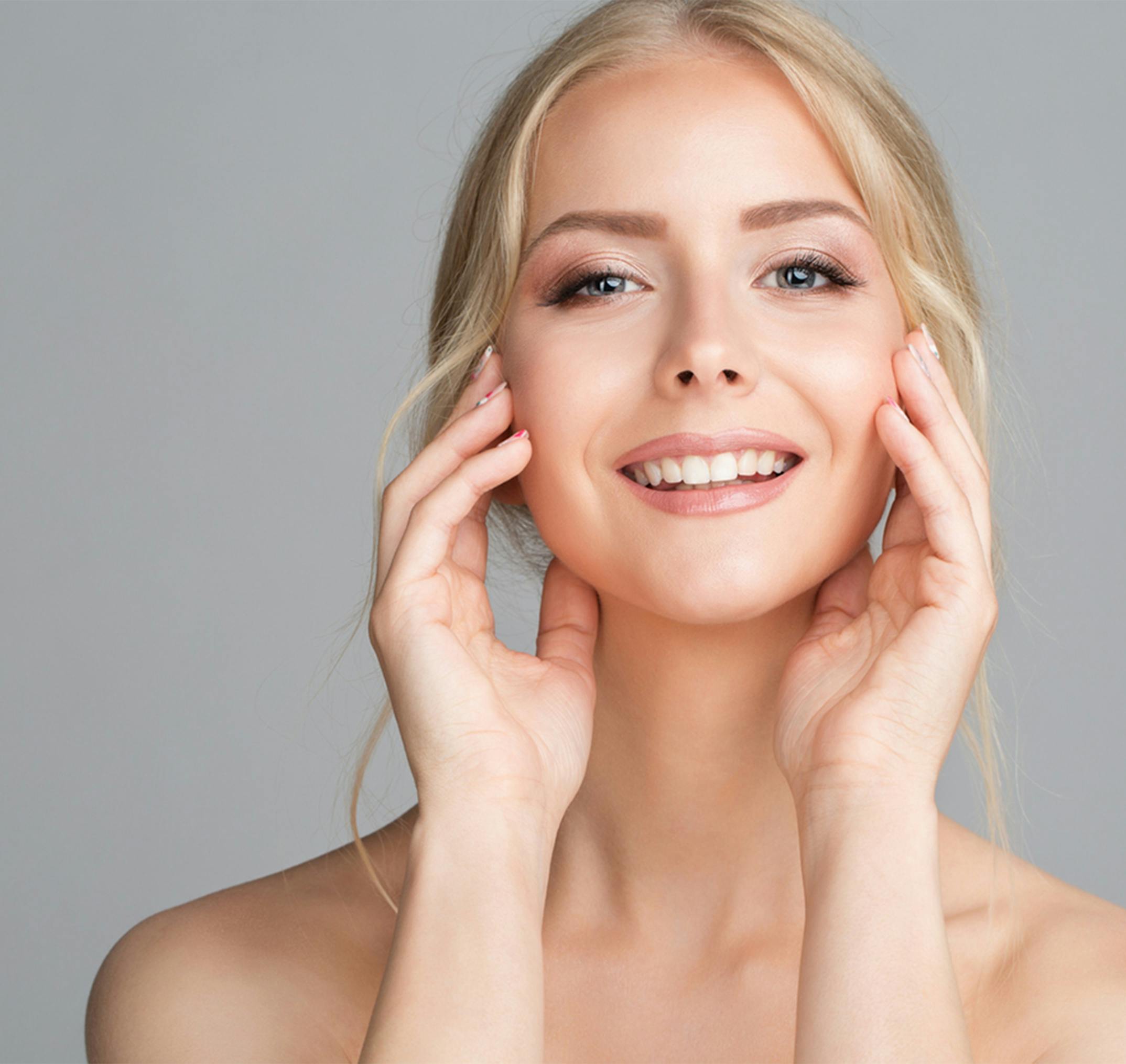smiling woman touching her face