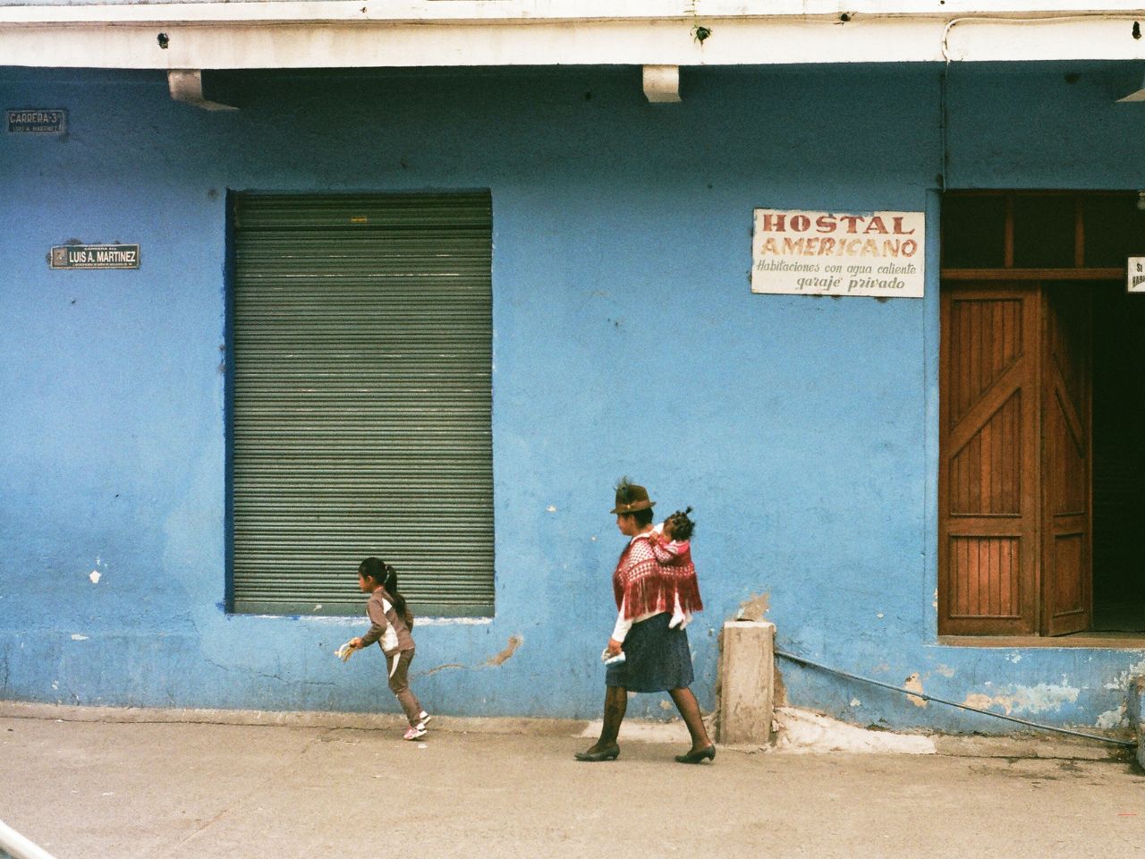 Mom and kids walking down a street in Honduras.