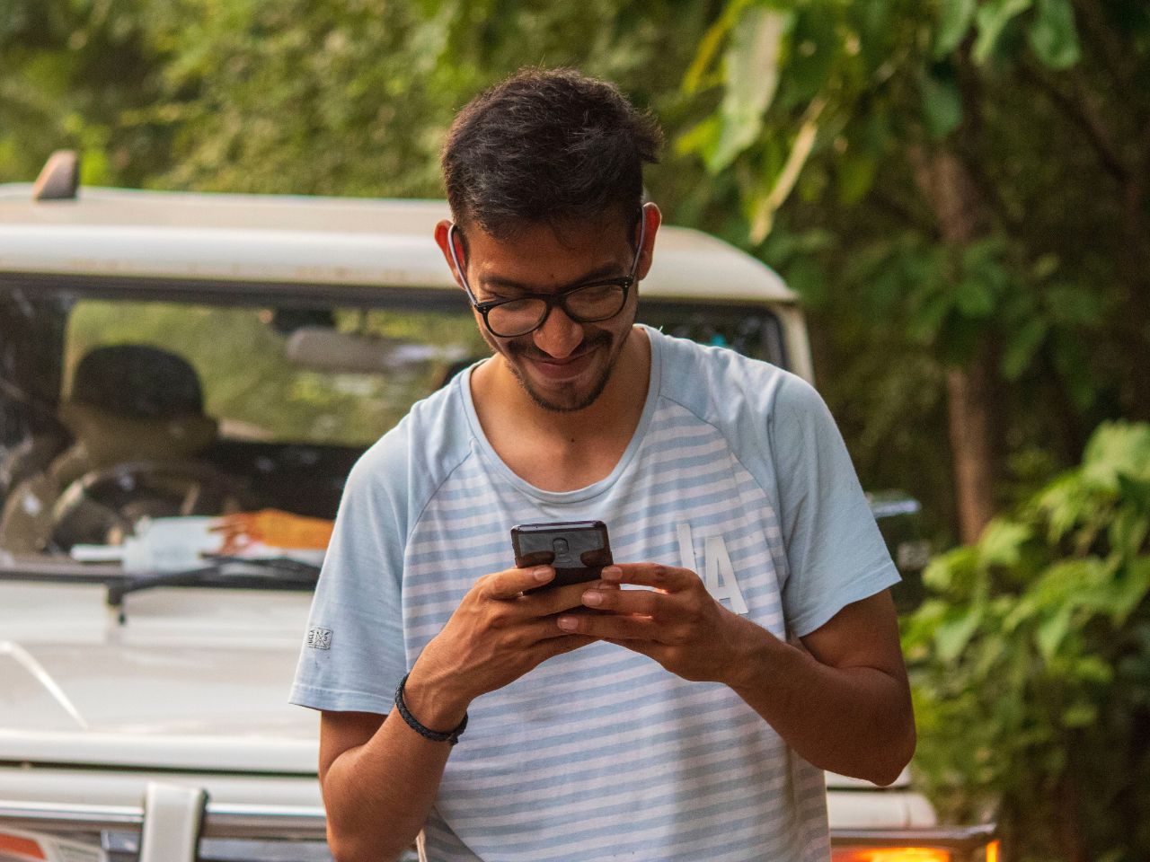 A man is using his cell phone to send an MTU