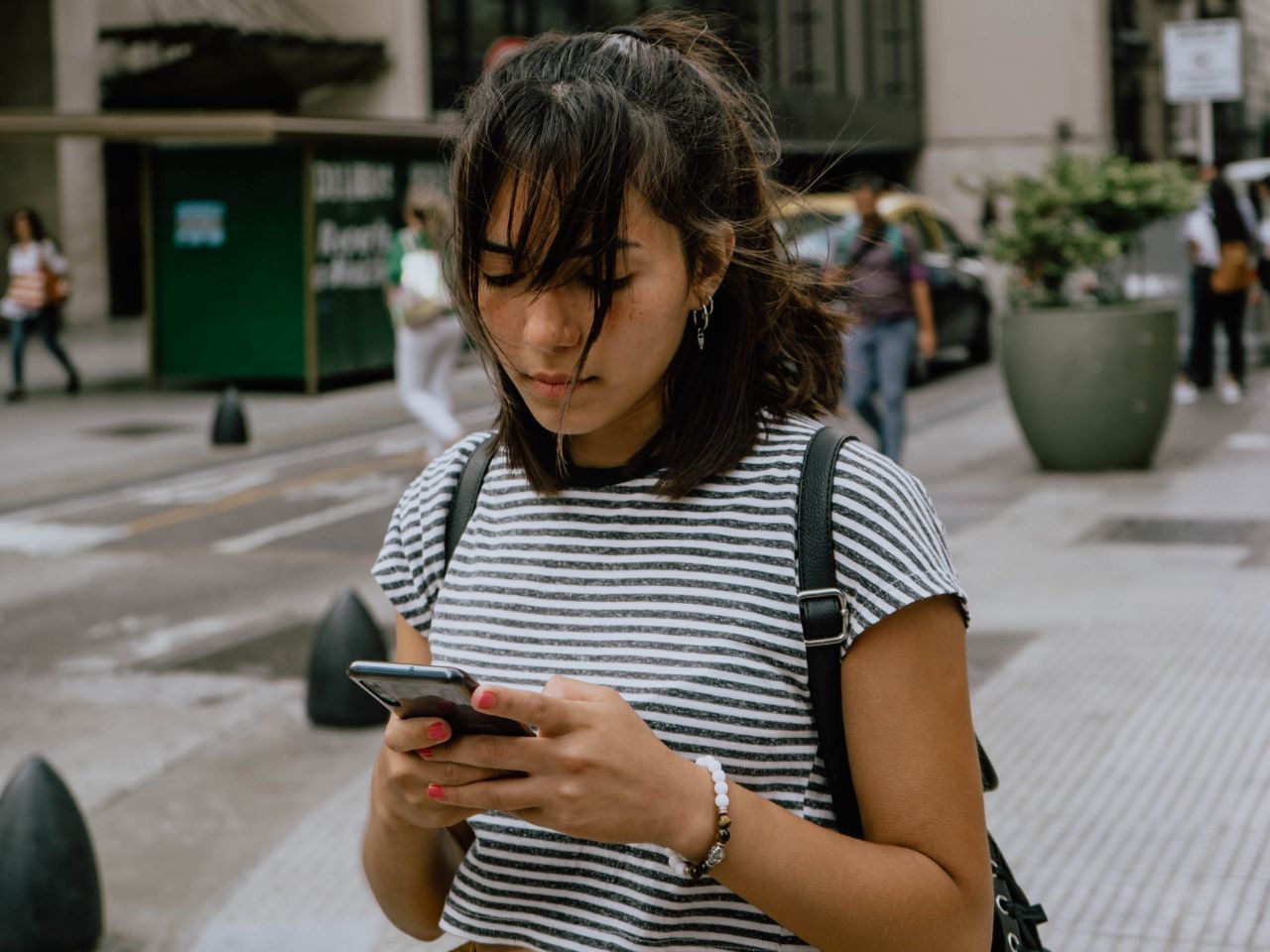 A woman is using her cell phone to send an MTU