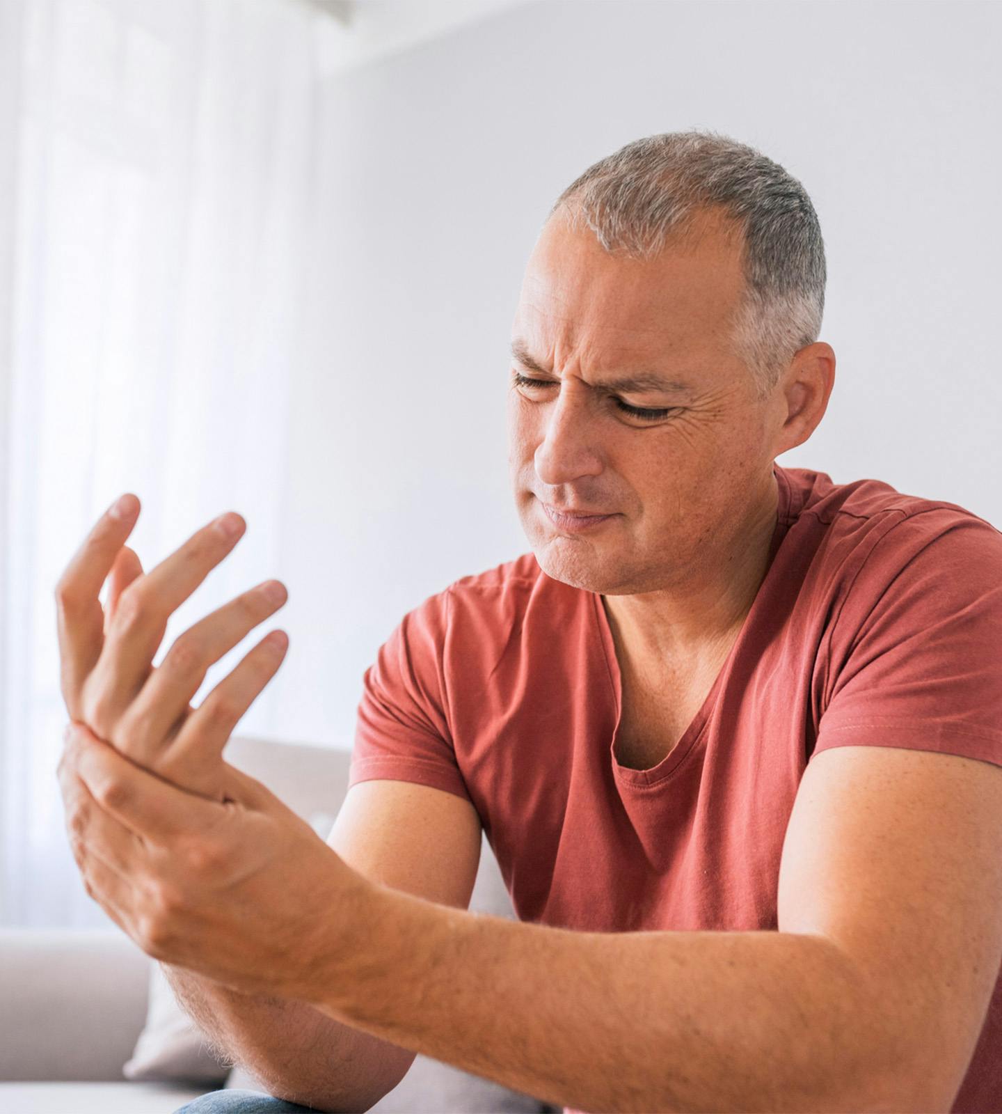 man holding his hand in pain