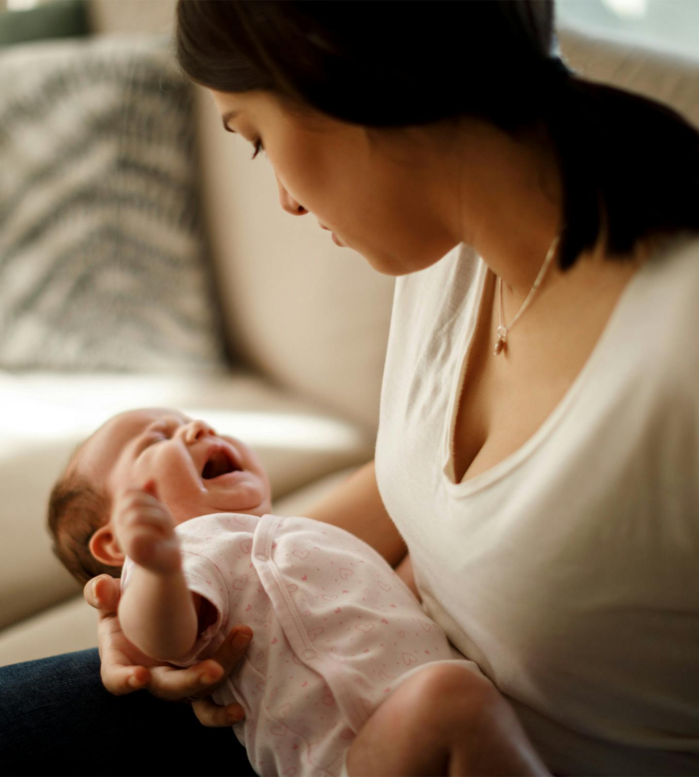 woman holding a crying baby