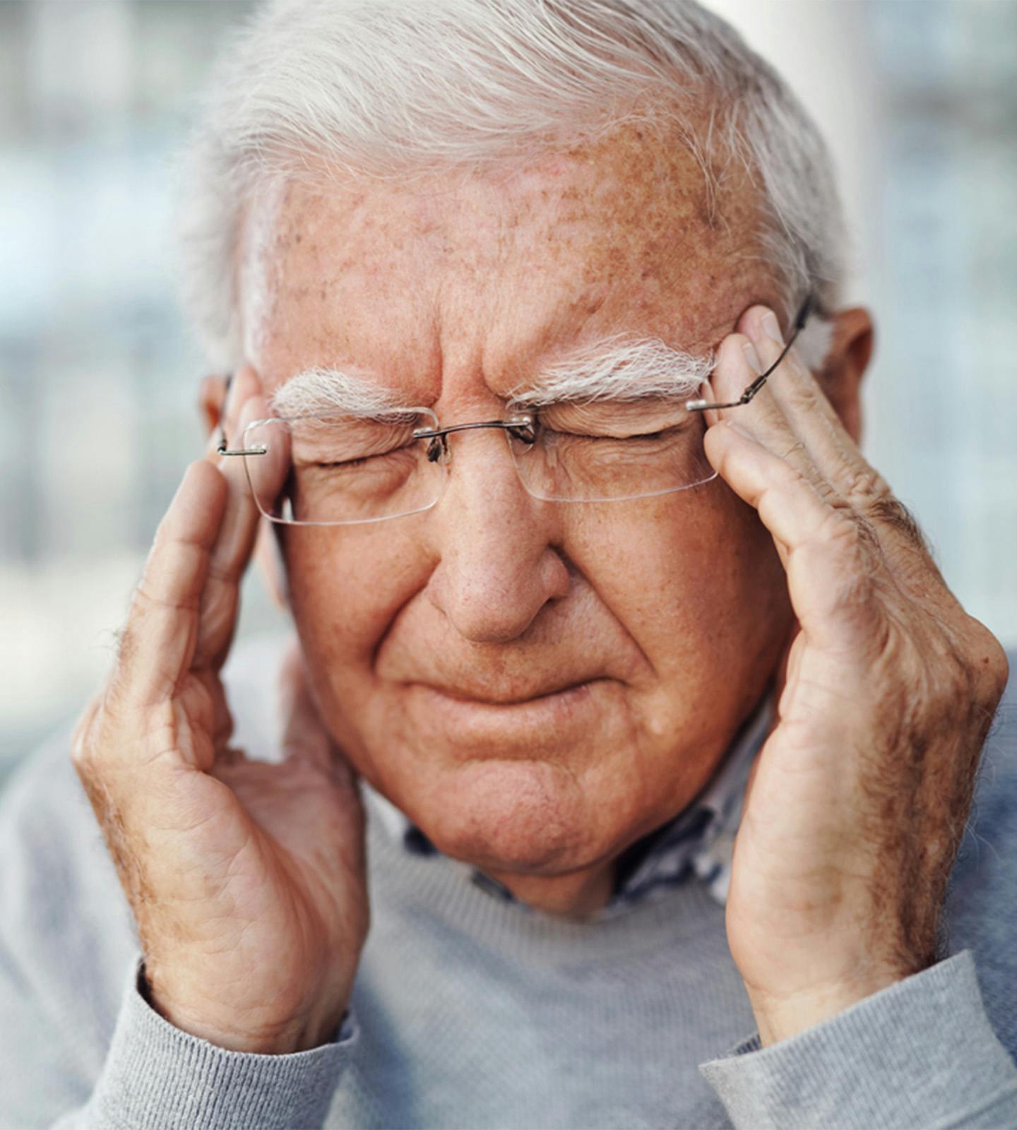 Man holding his head in pain