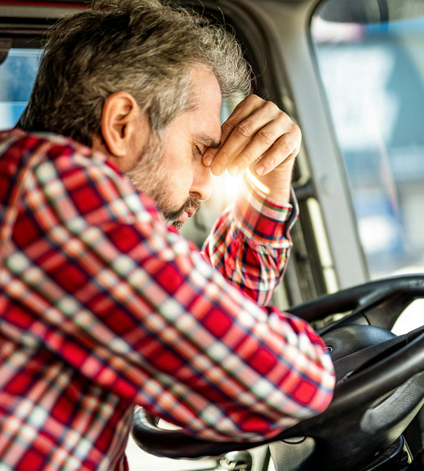man pinching the bridge of his nose