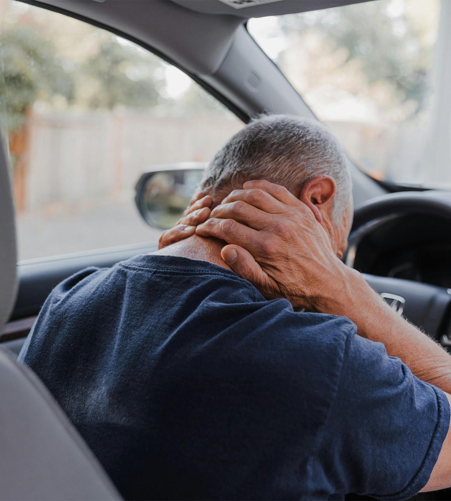 man holding his neck in pain