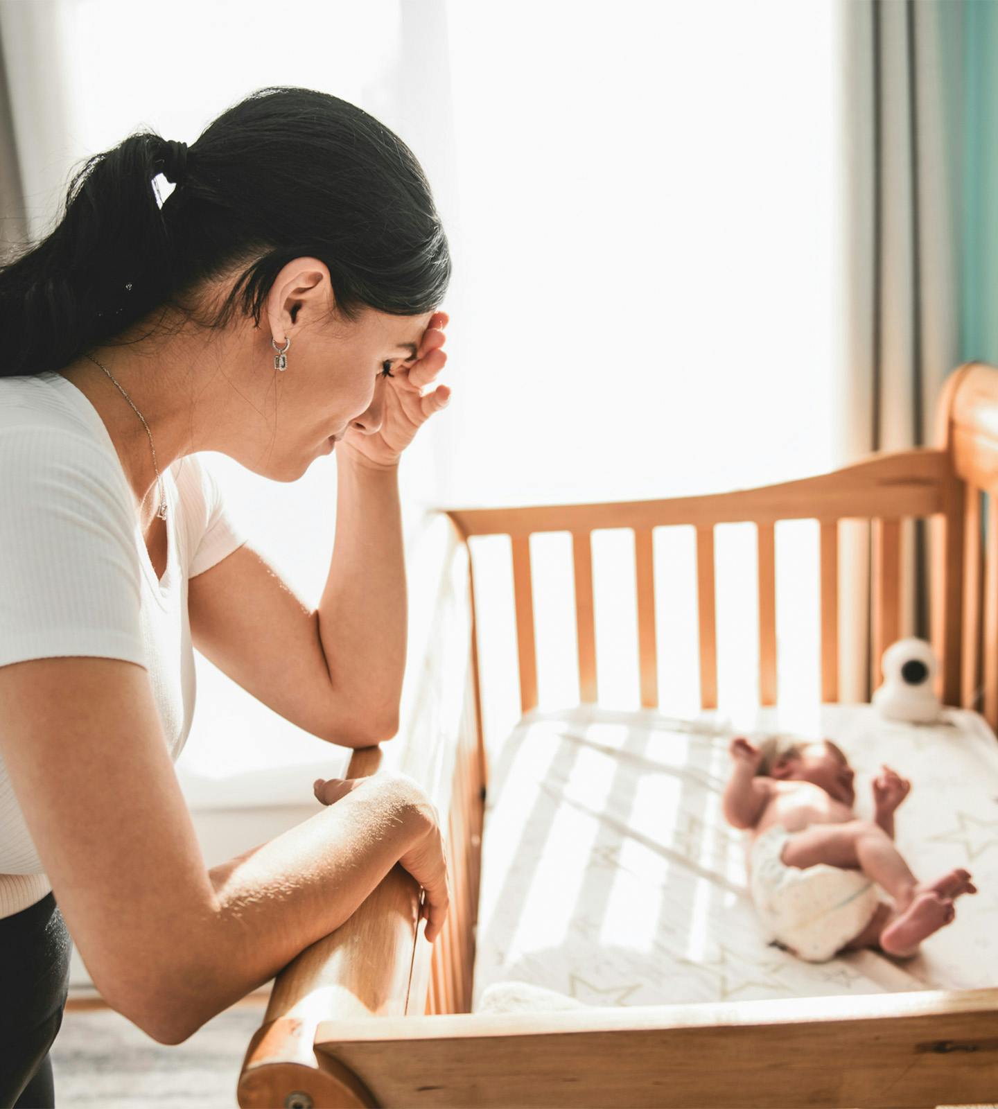 woman looking down at a baby