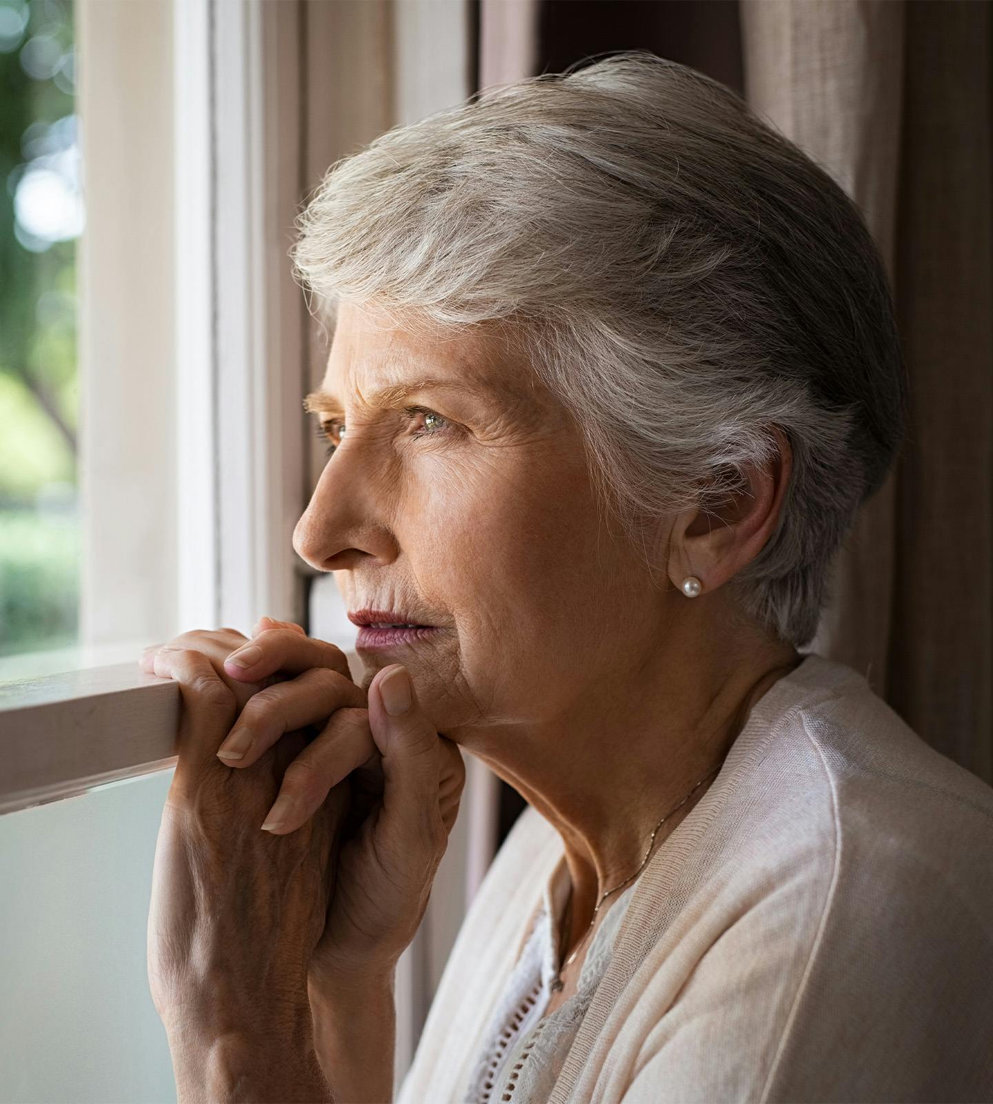 older woman looking out a window
