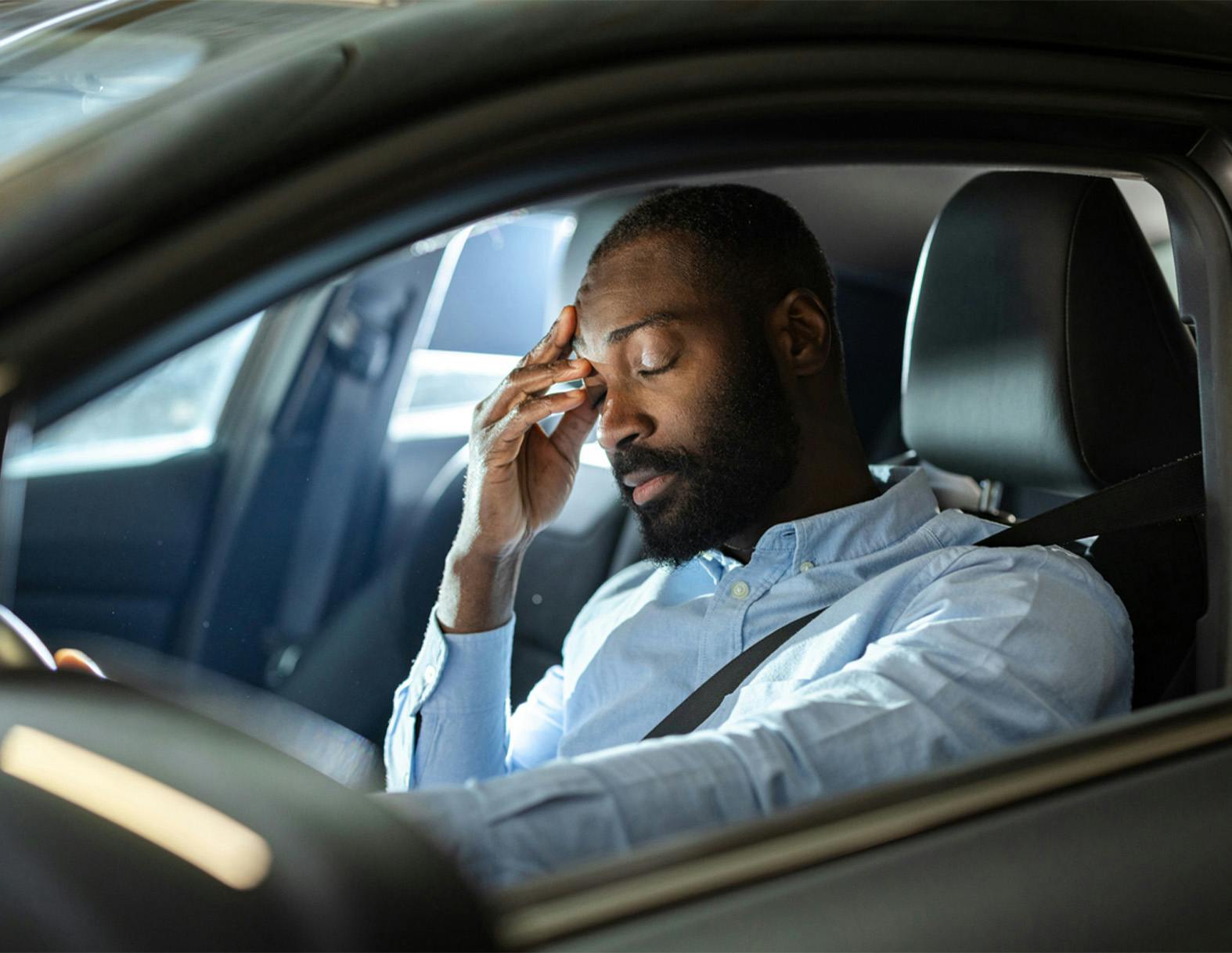 man holding his head in pain