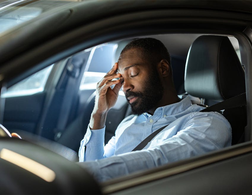 man holding his head in pain