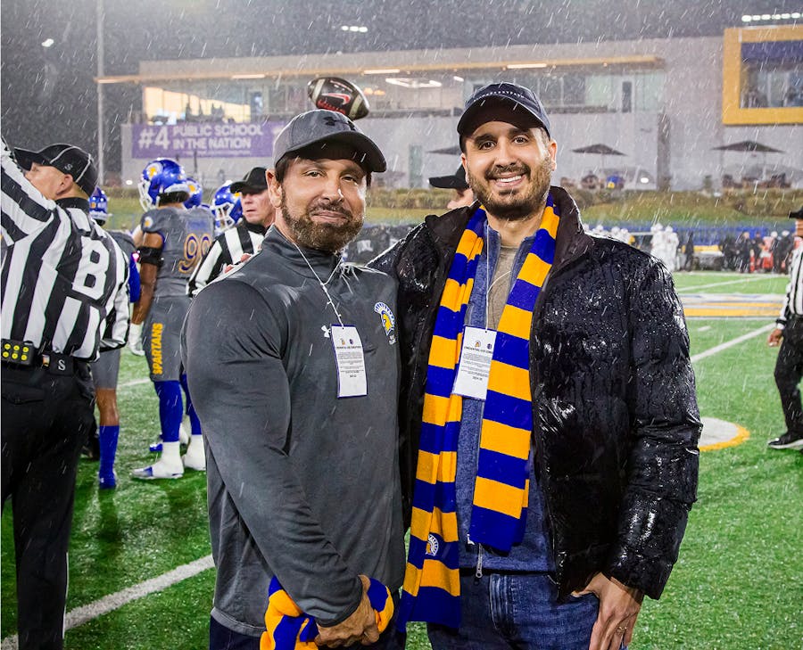 habbas standing in the rain at a football game