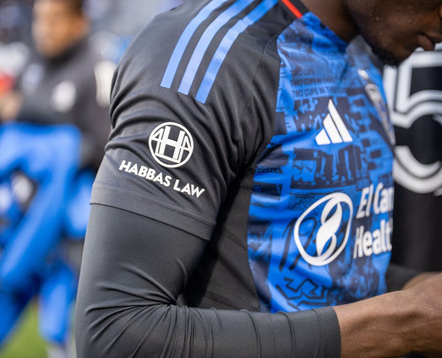 soccer player with a Habbas Law logo on their shoulder