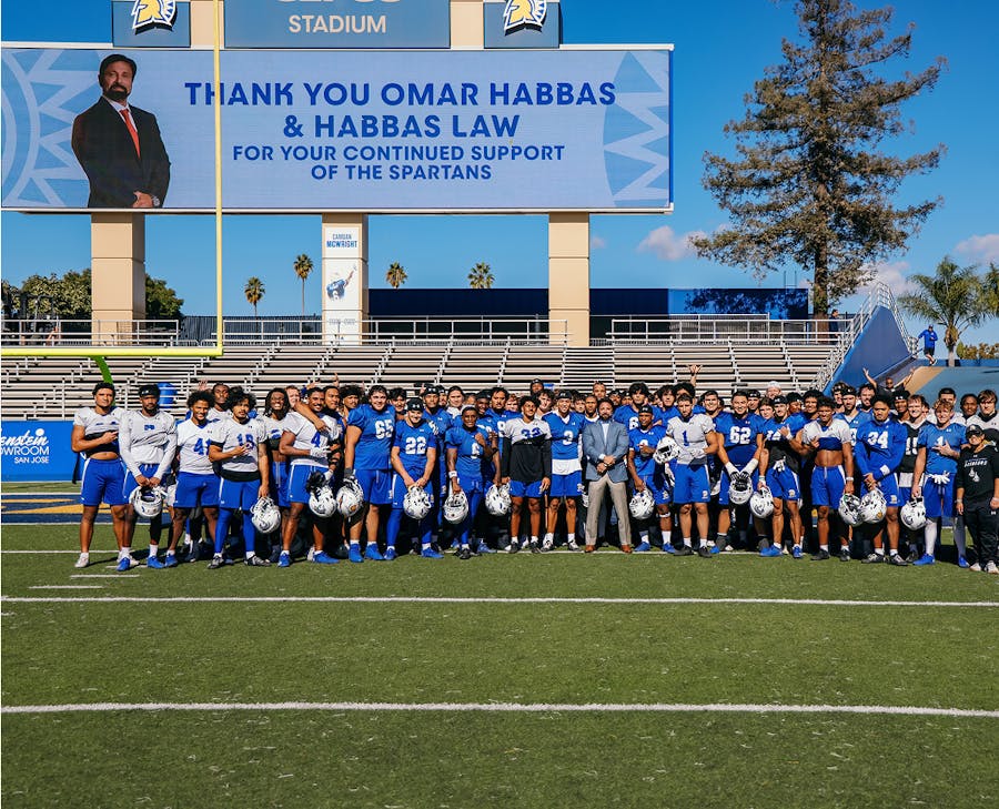 Habbas staning with a football team