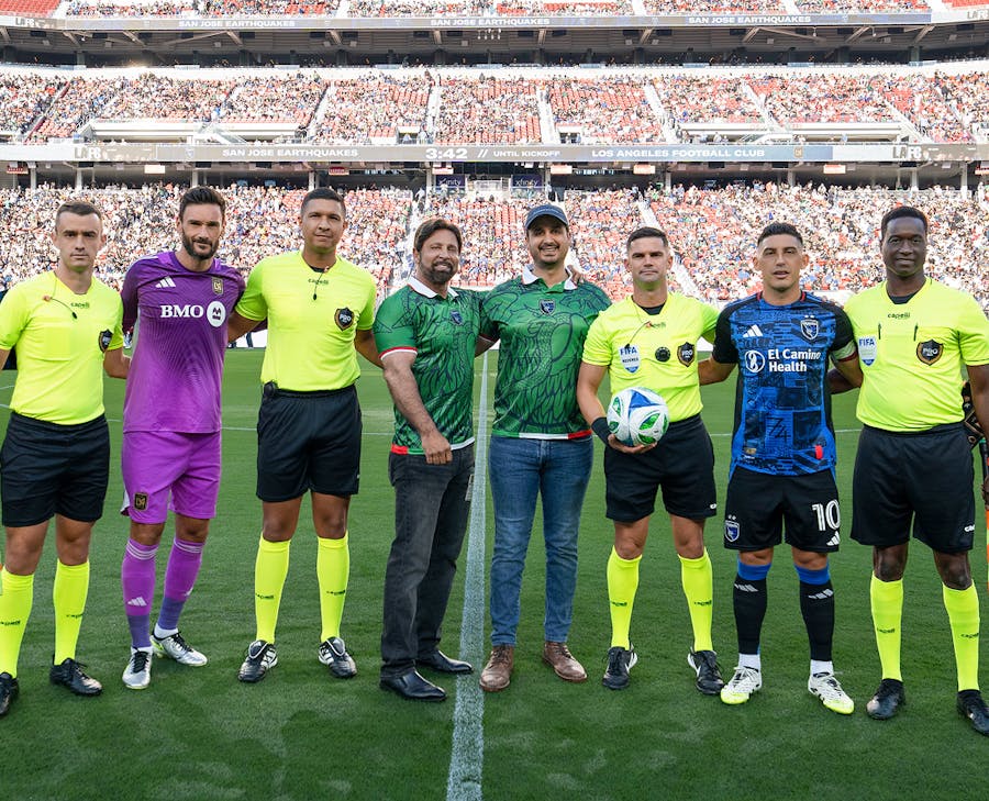 Habbas standing with soccer players