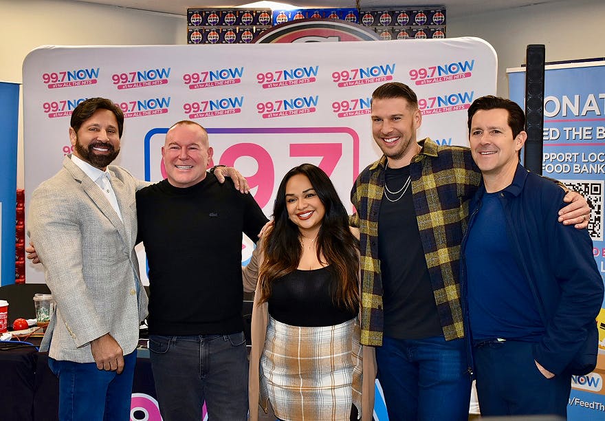 Habbas staning for a photo with four people