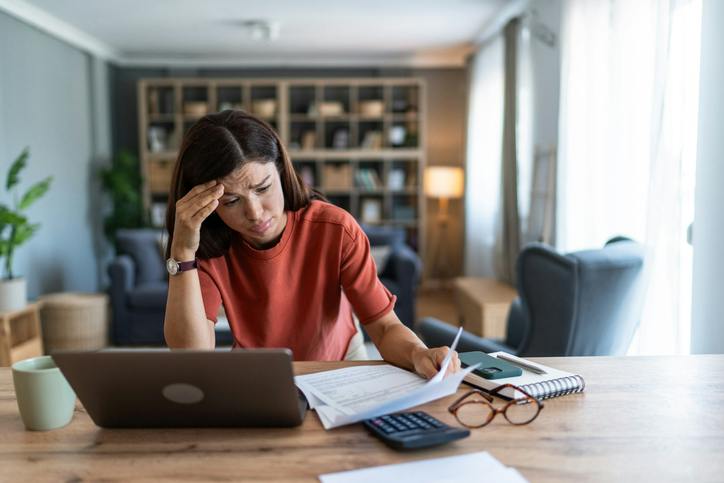 distressed woman looking at papers