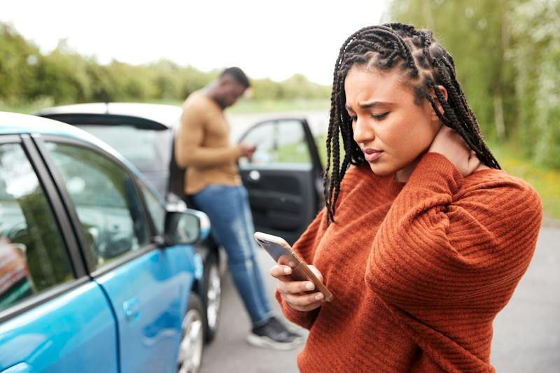 people on phone after car accident