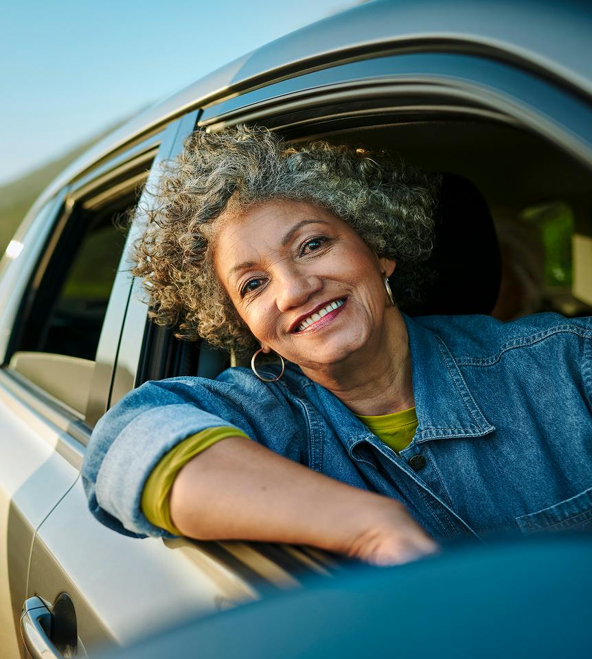 woman smiling out the car window