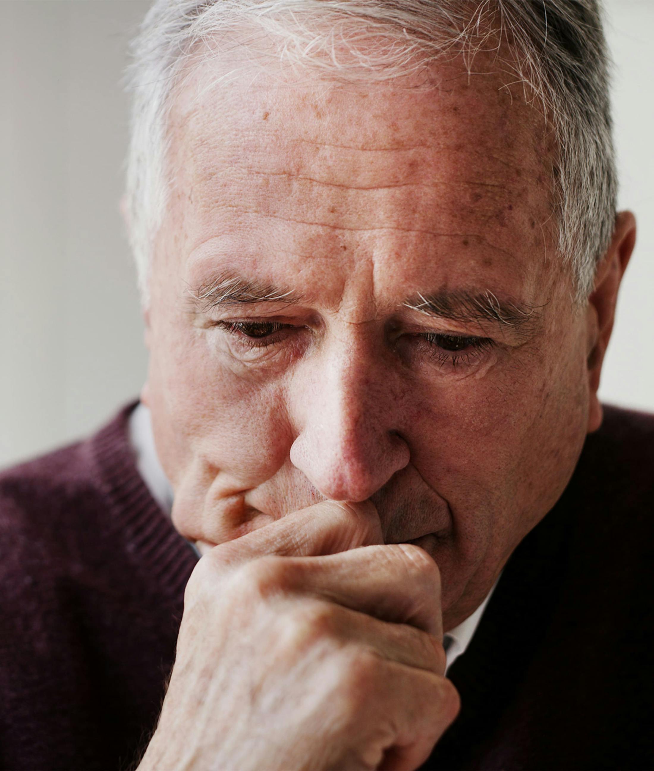 man holding his face