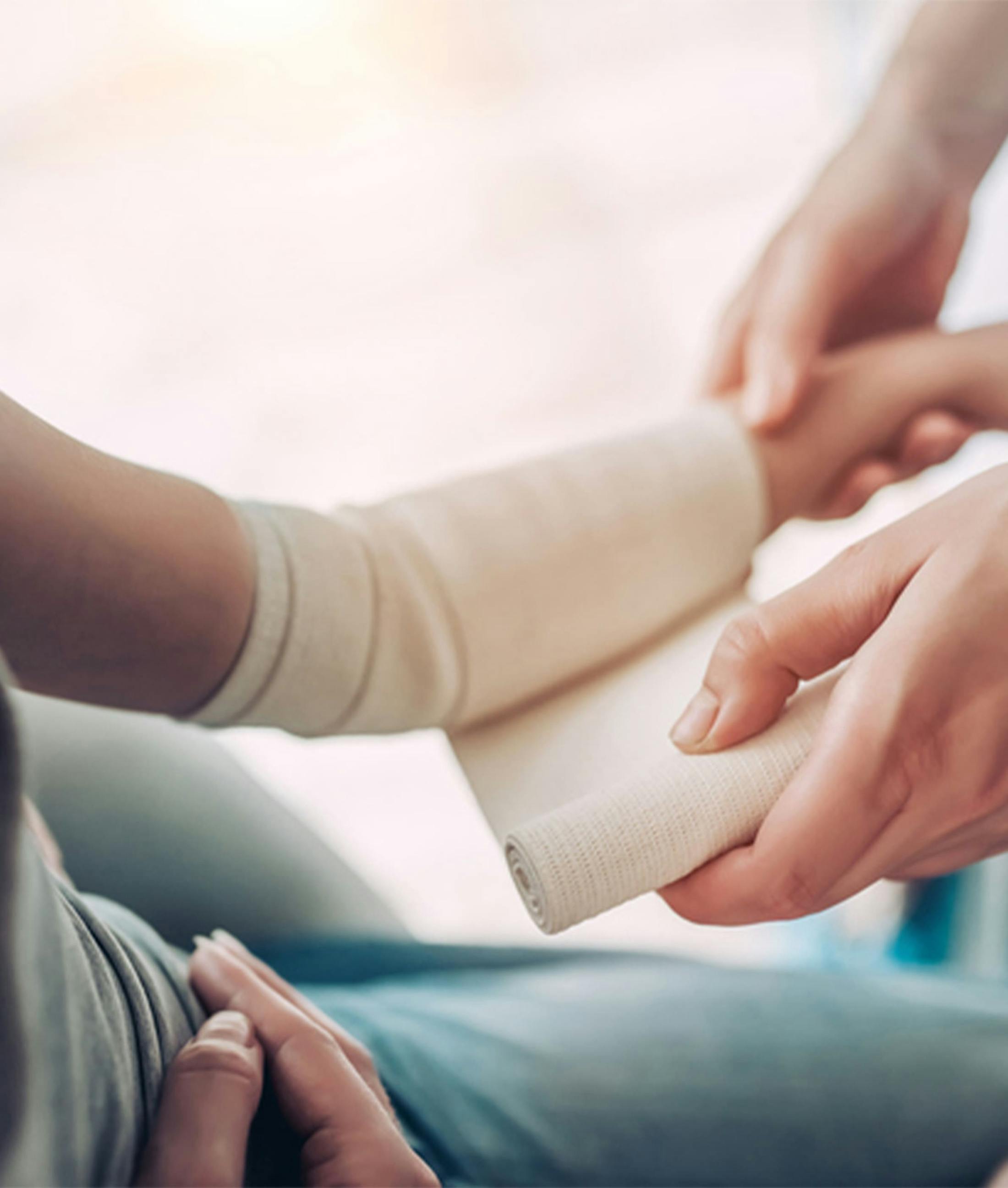 woman getting her arm bandaged
