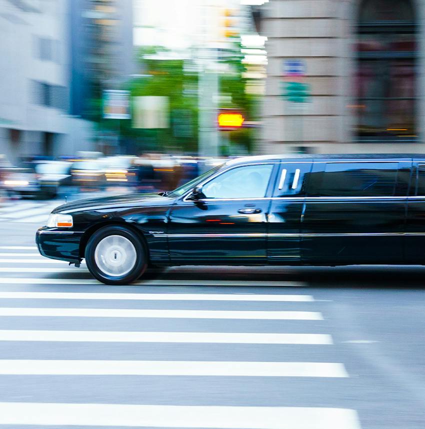 limousine driving through an intersection