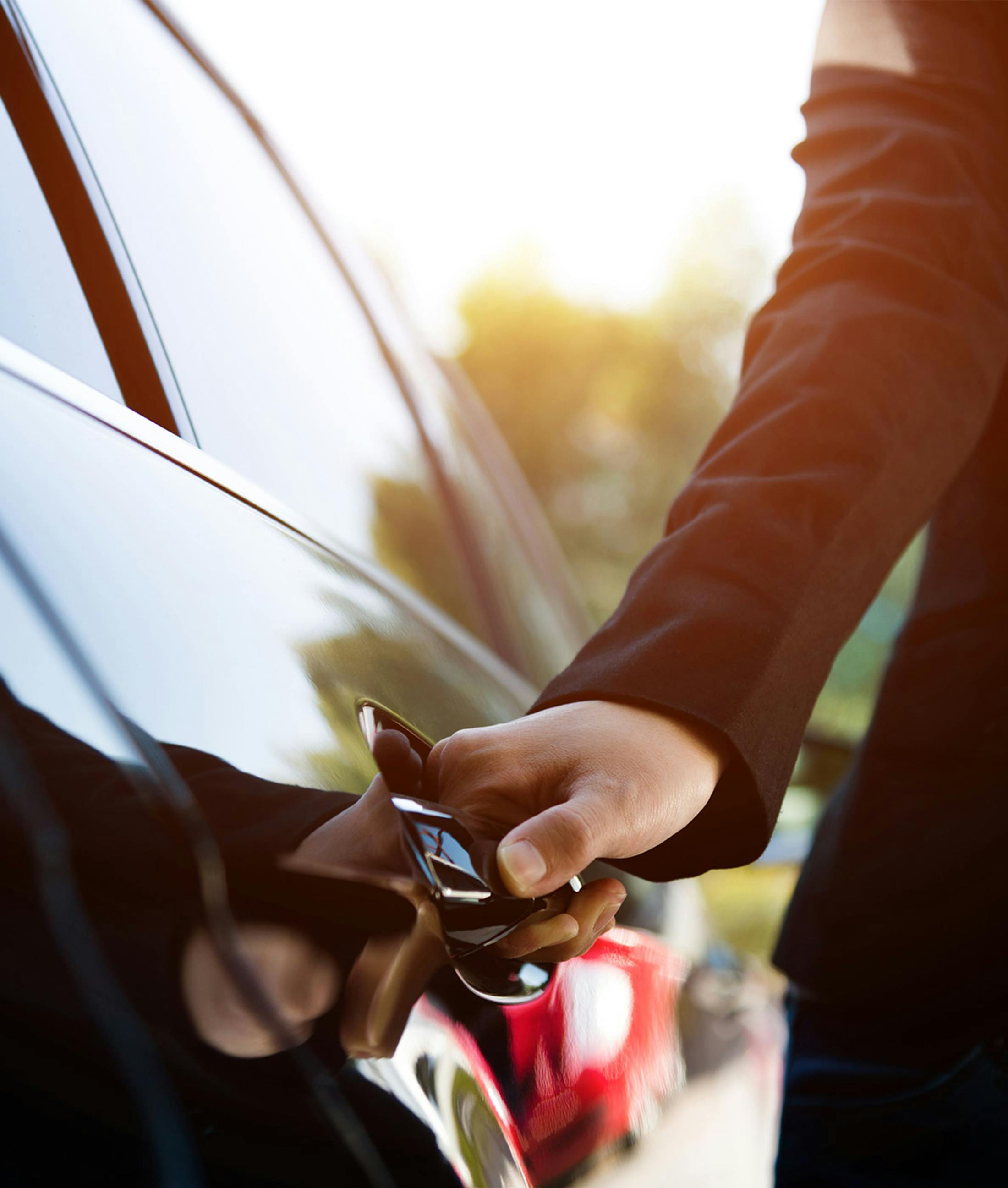 person opening the door of a limousine