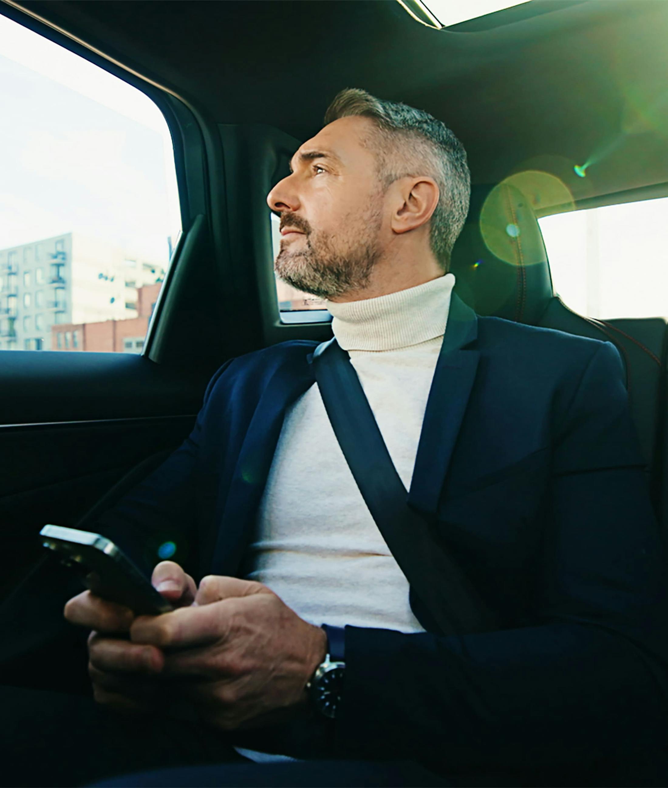 man looking out a car window