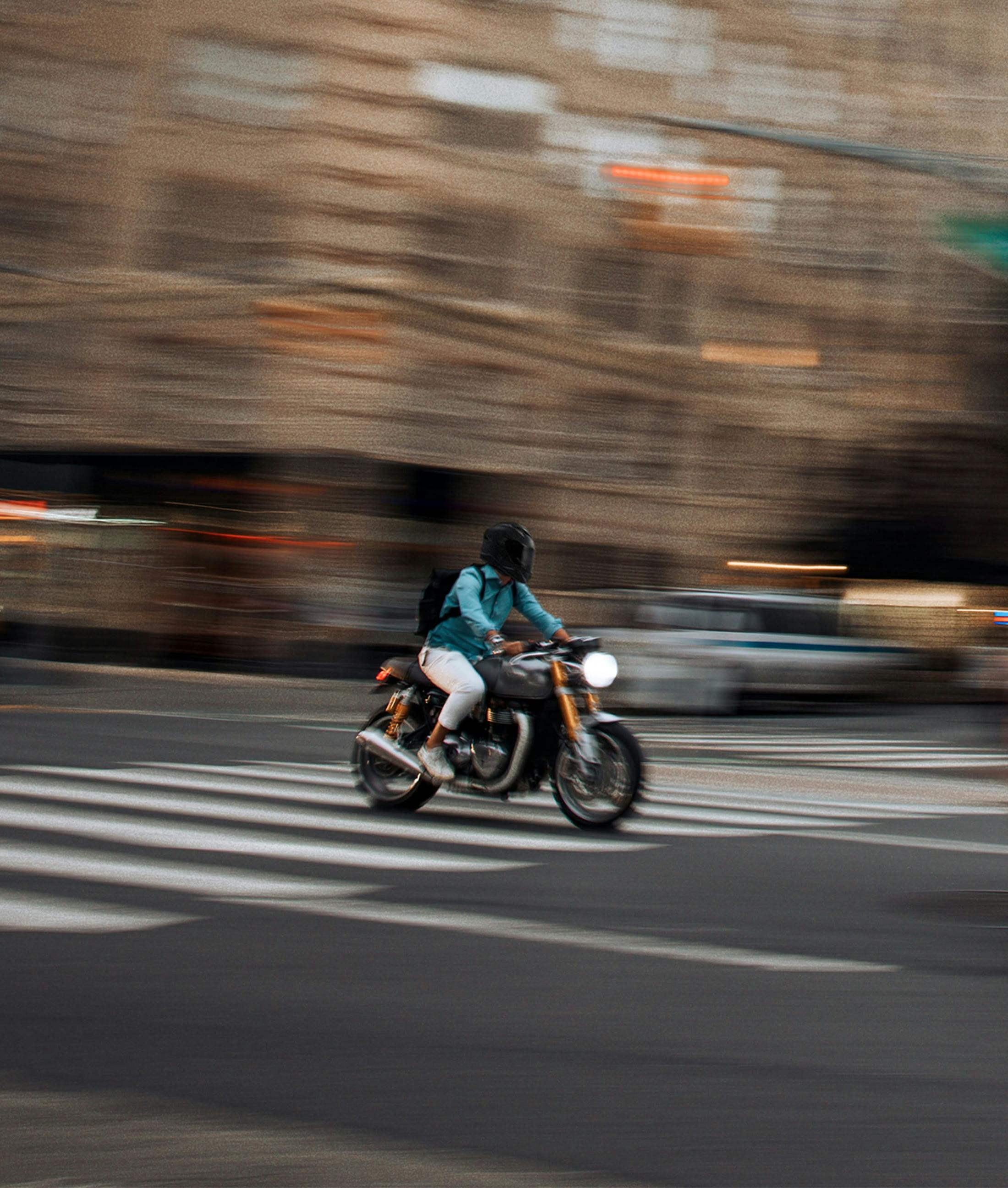 person riding a motorcycle in a city