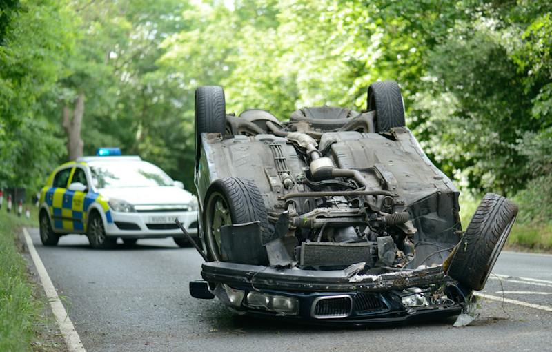 Car flipped upside down on the road