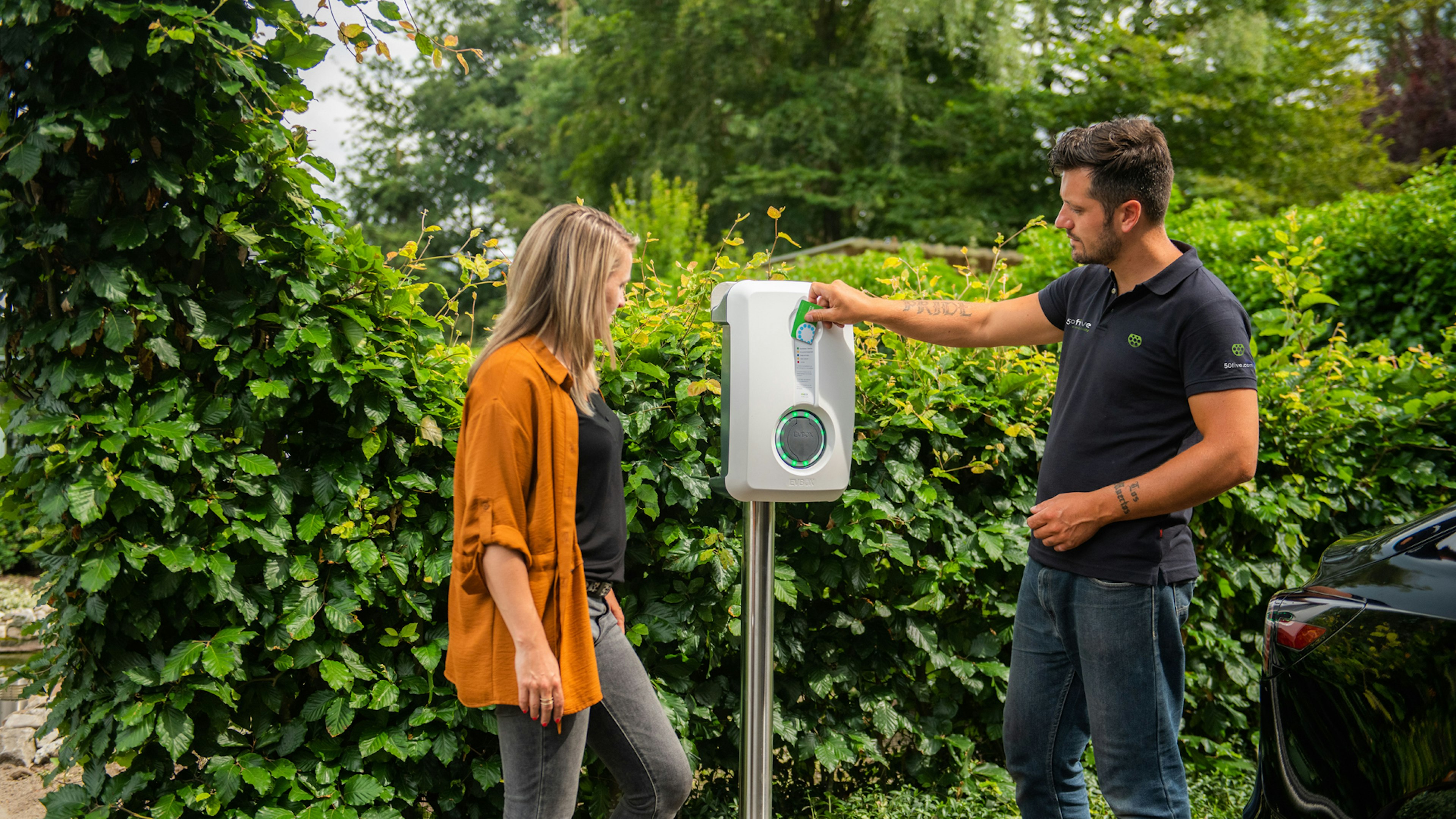 Installer showing a customer a newly installed EV charger