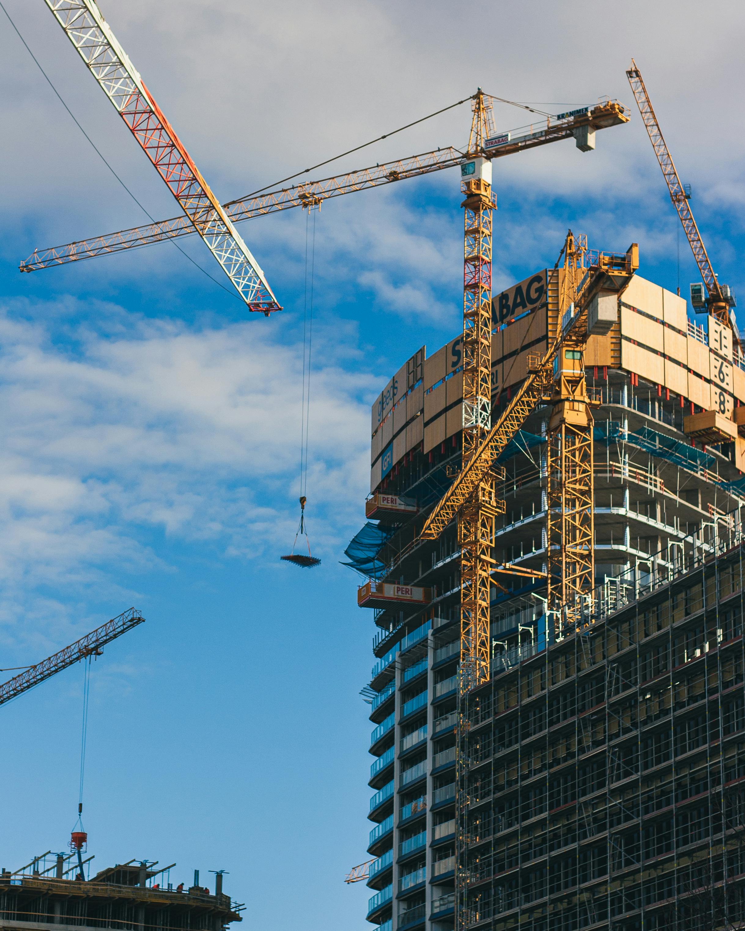 Tower cranes around a high-rise under construction