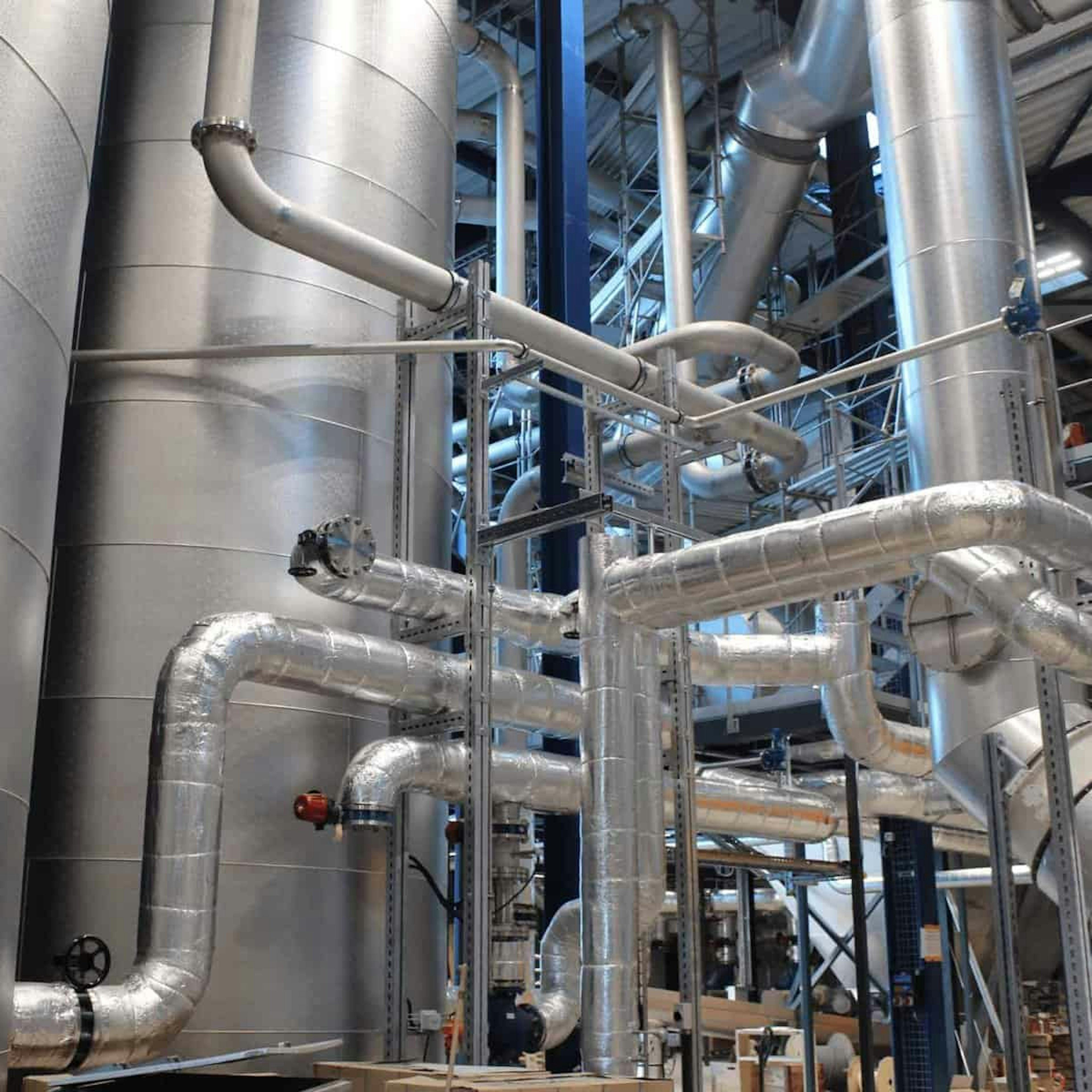 Insulated pipes and tanks in an energy plant
