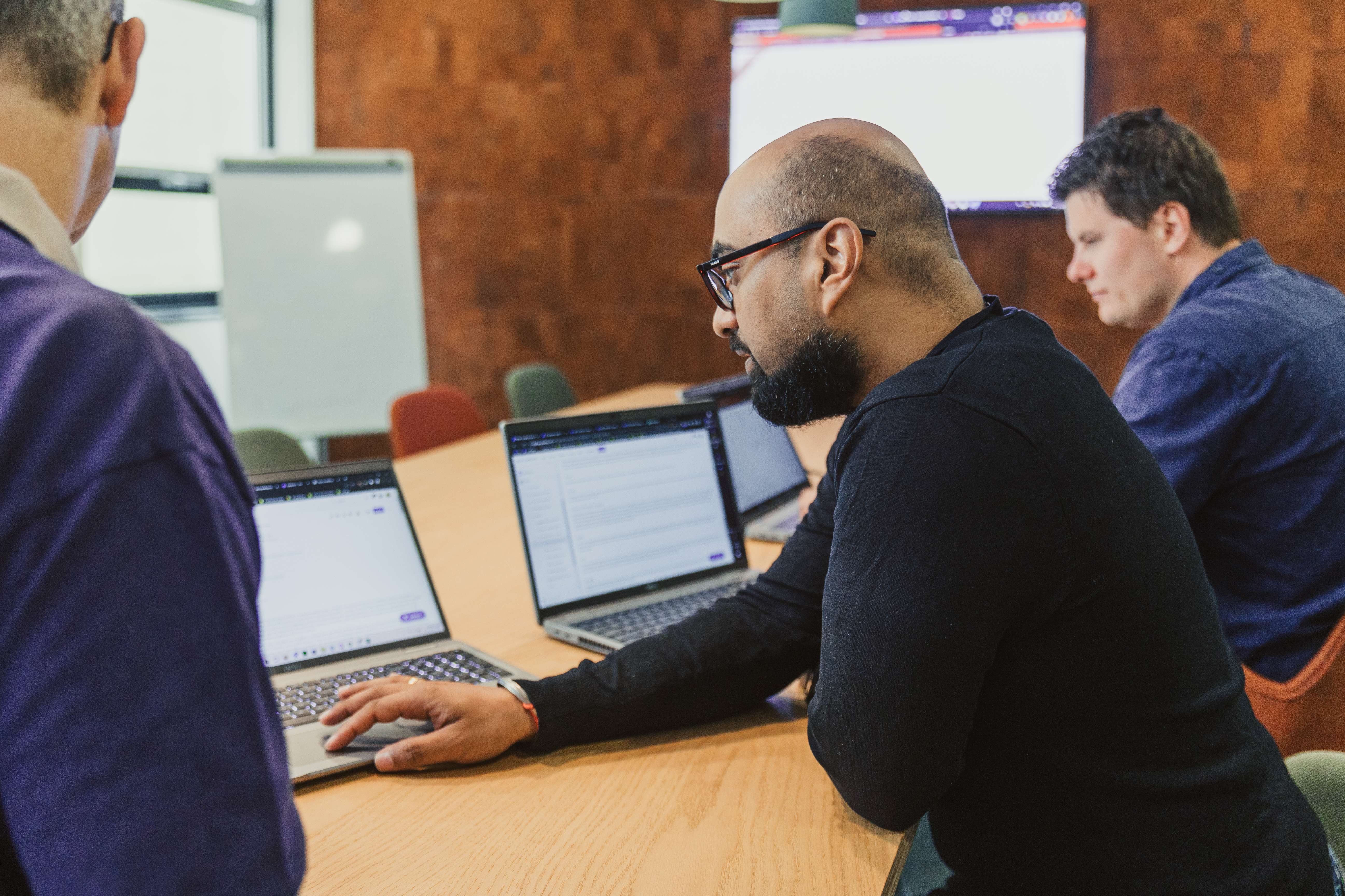 Colleagues on laptops during a training session