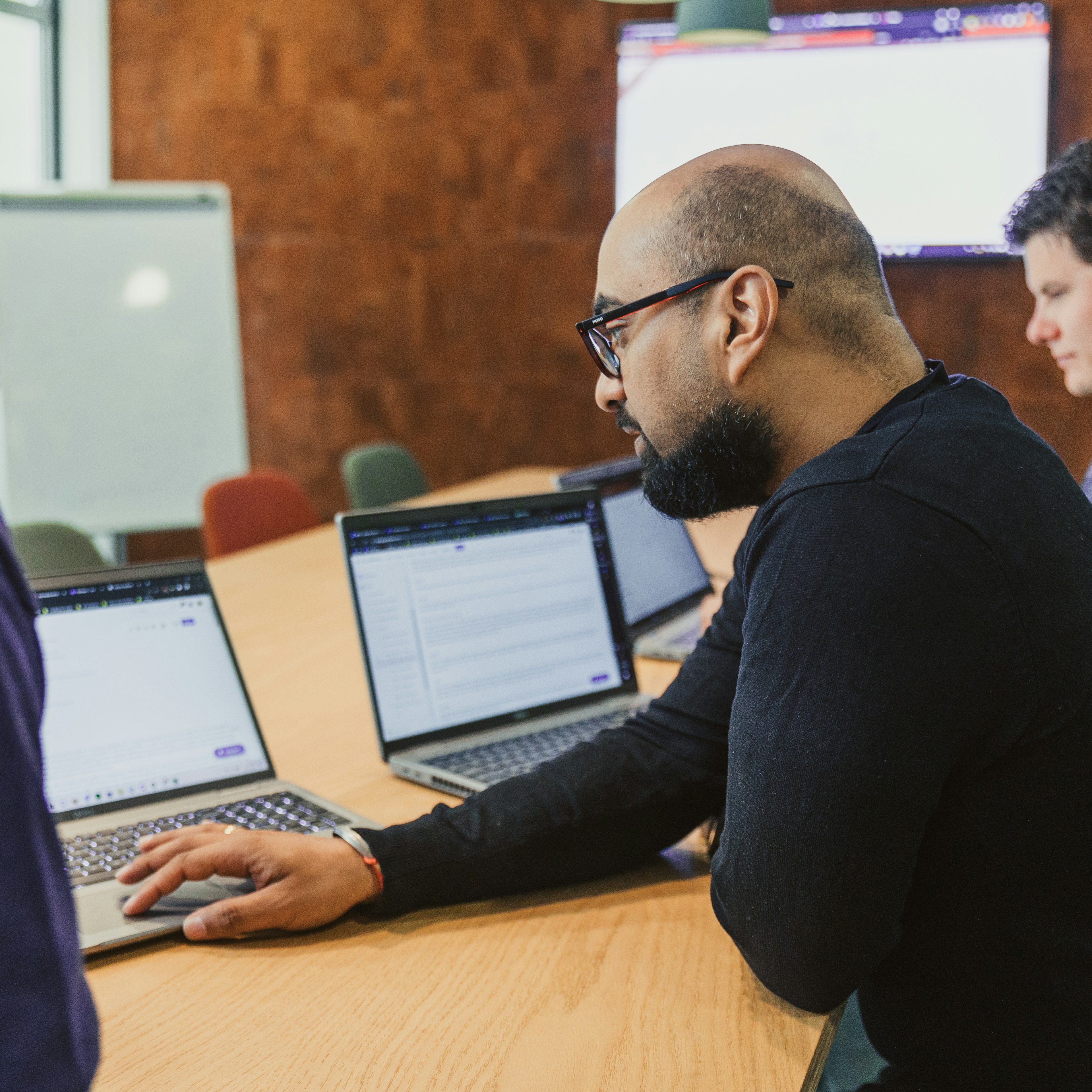 Colleagues on laptops during a training session
