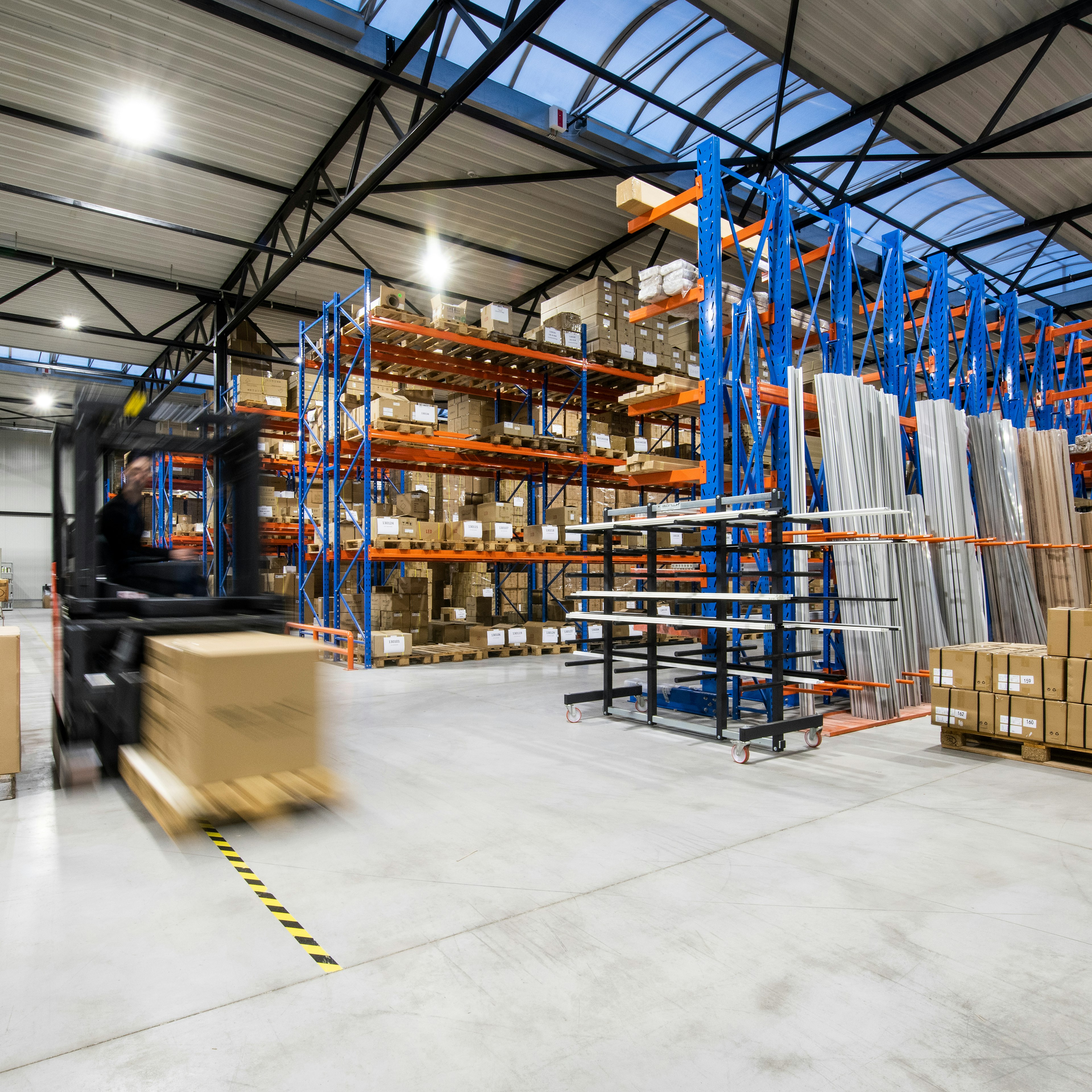 Forklift moving a pallet through a warehouse