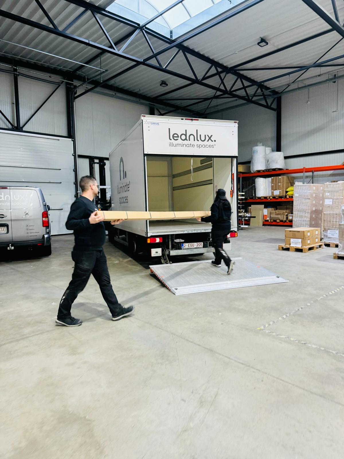 Workers loading boxes into a delivery truck