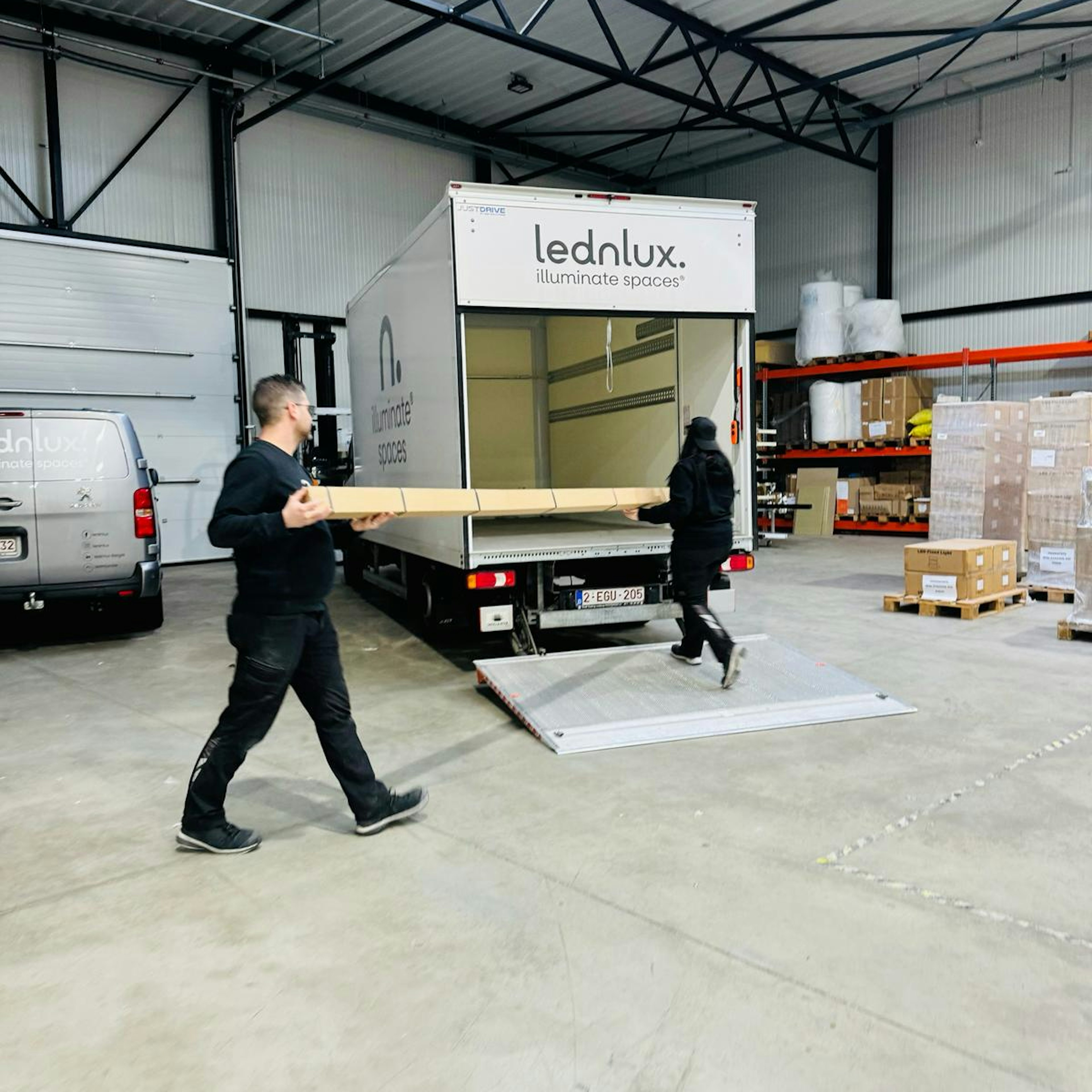 Workers loading boxes into a delivery truck