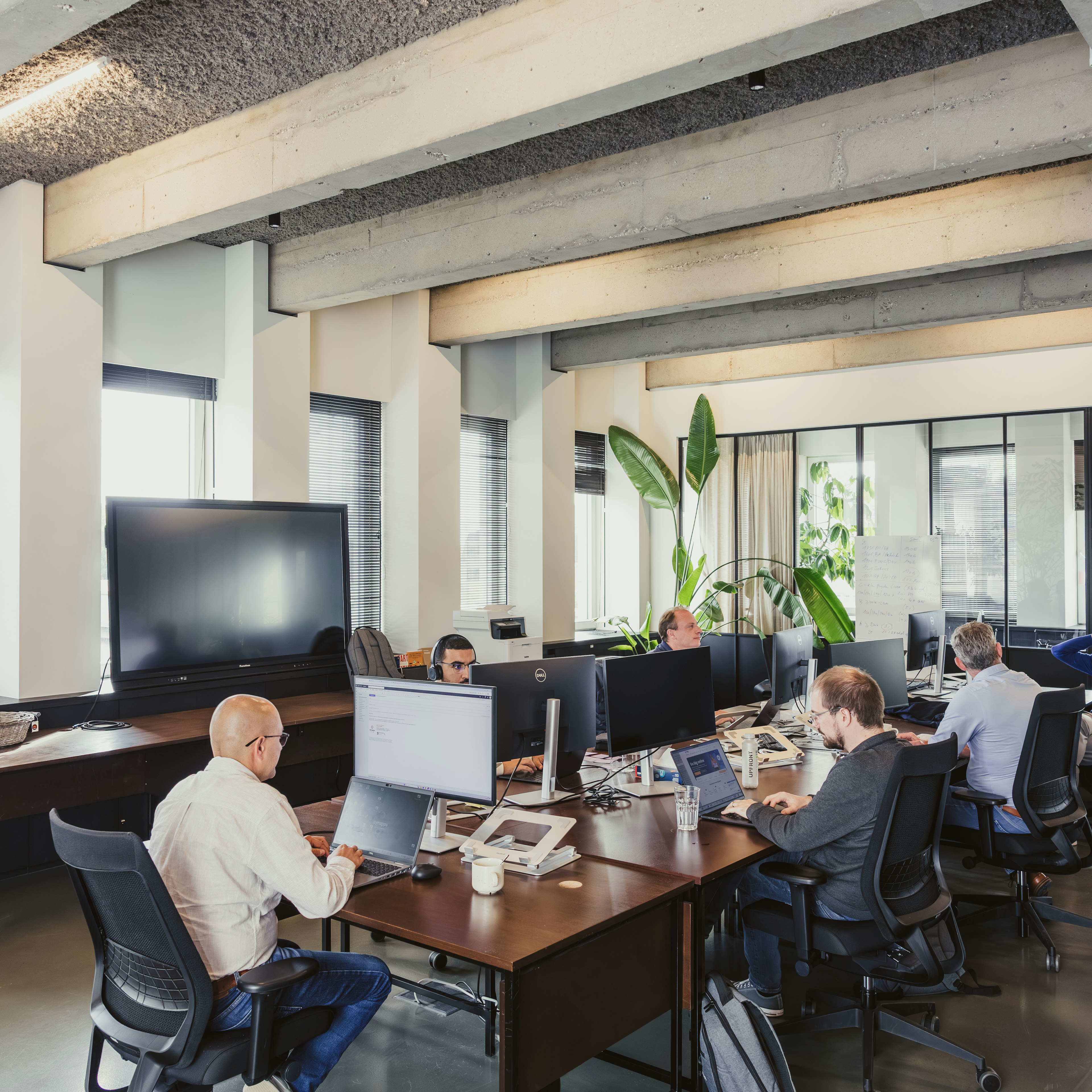 Une équipe travaillant sur des ordinateurs portables dans un bureau en open space