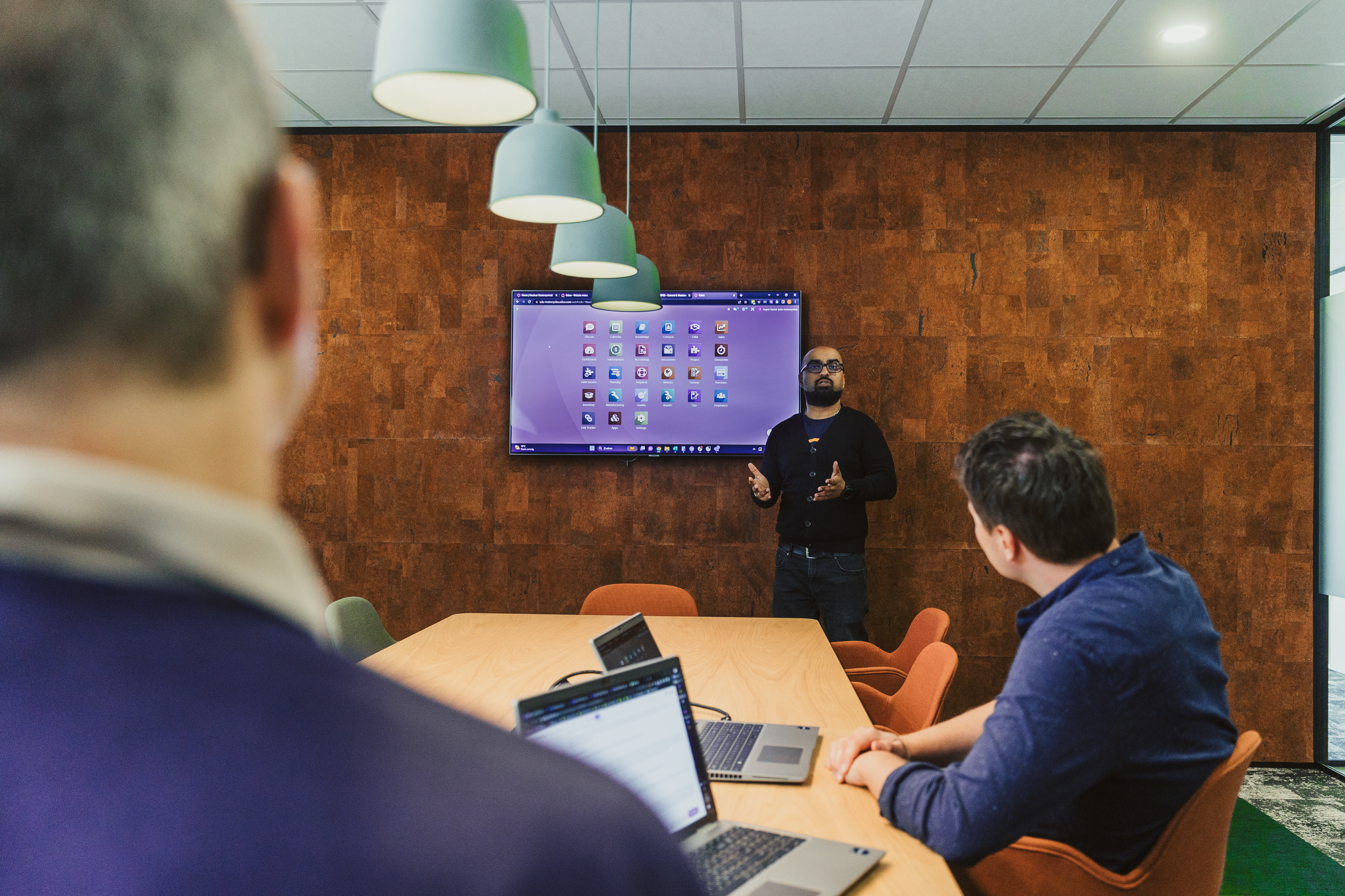 Presenter giving a demo on screen in a meeting room
