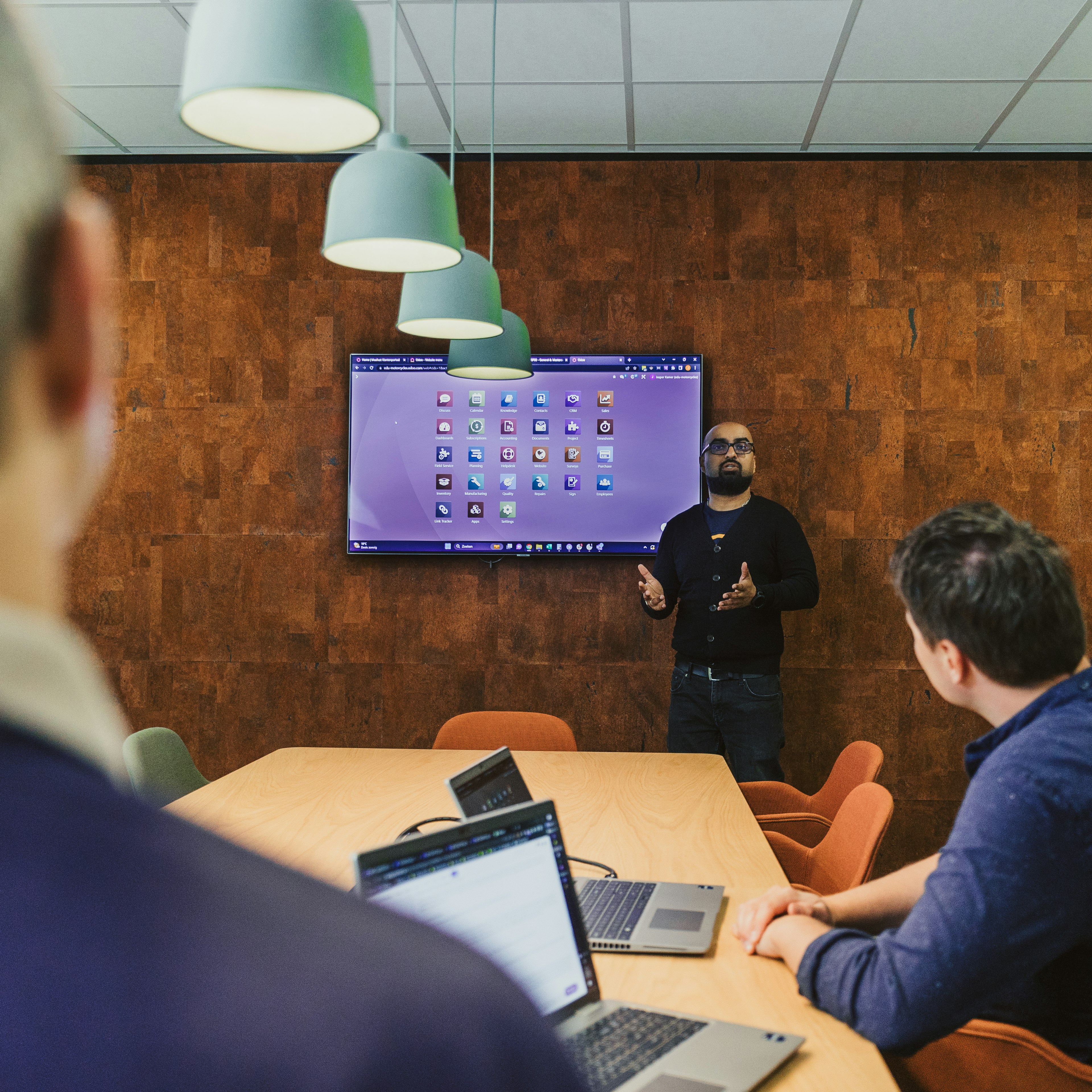 Presenter giving a demo on screen in a meeting room