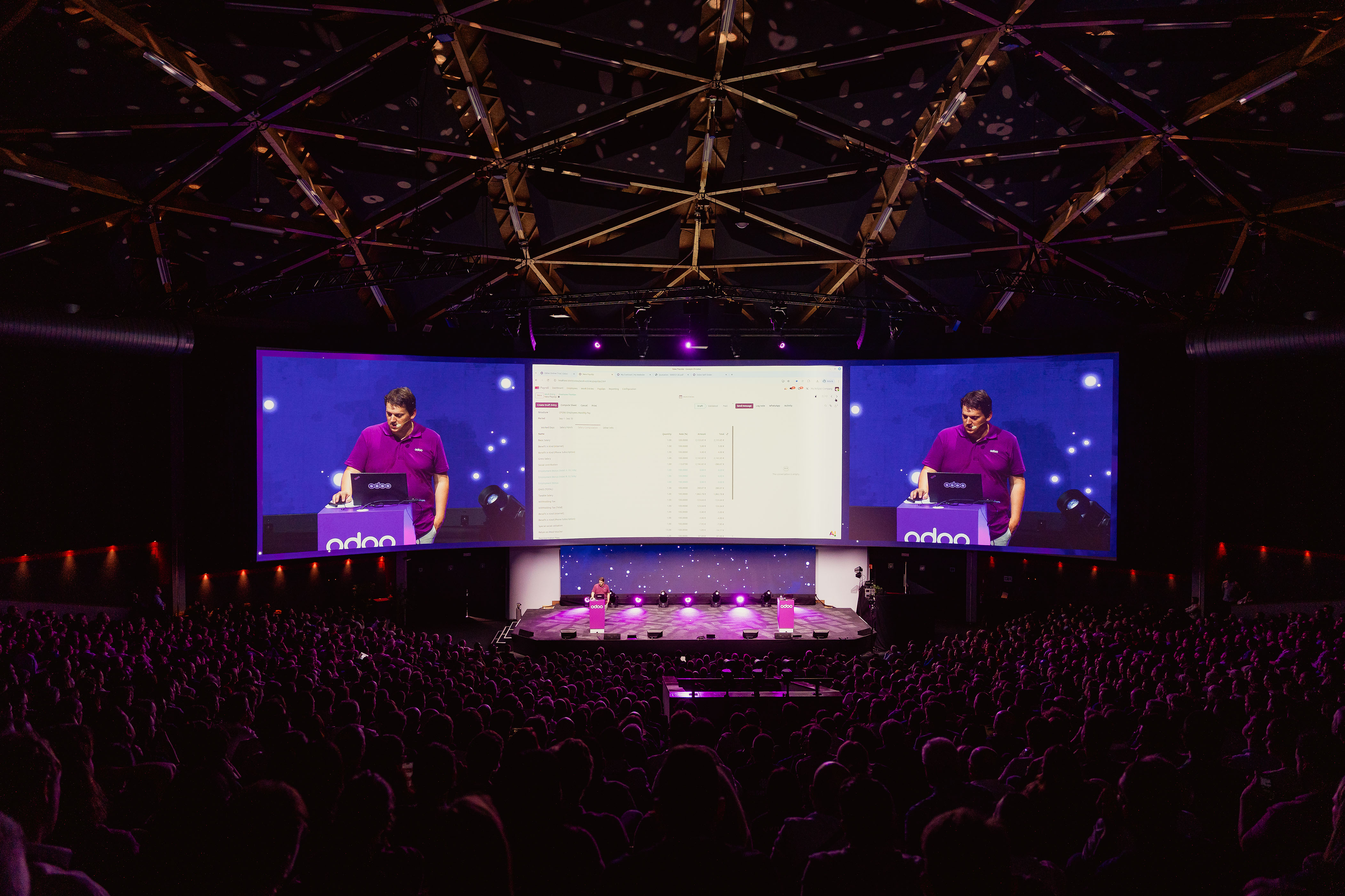Packed Odoo keynote with speaker on giant screens