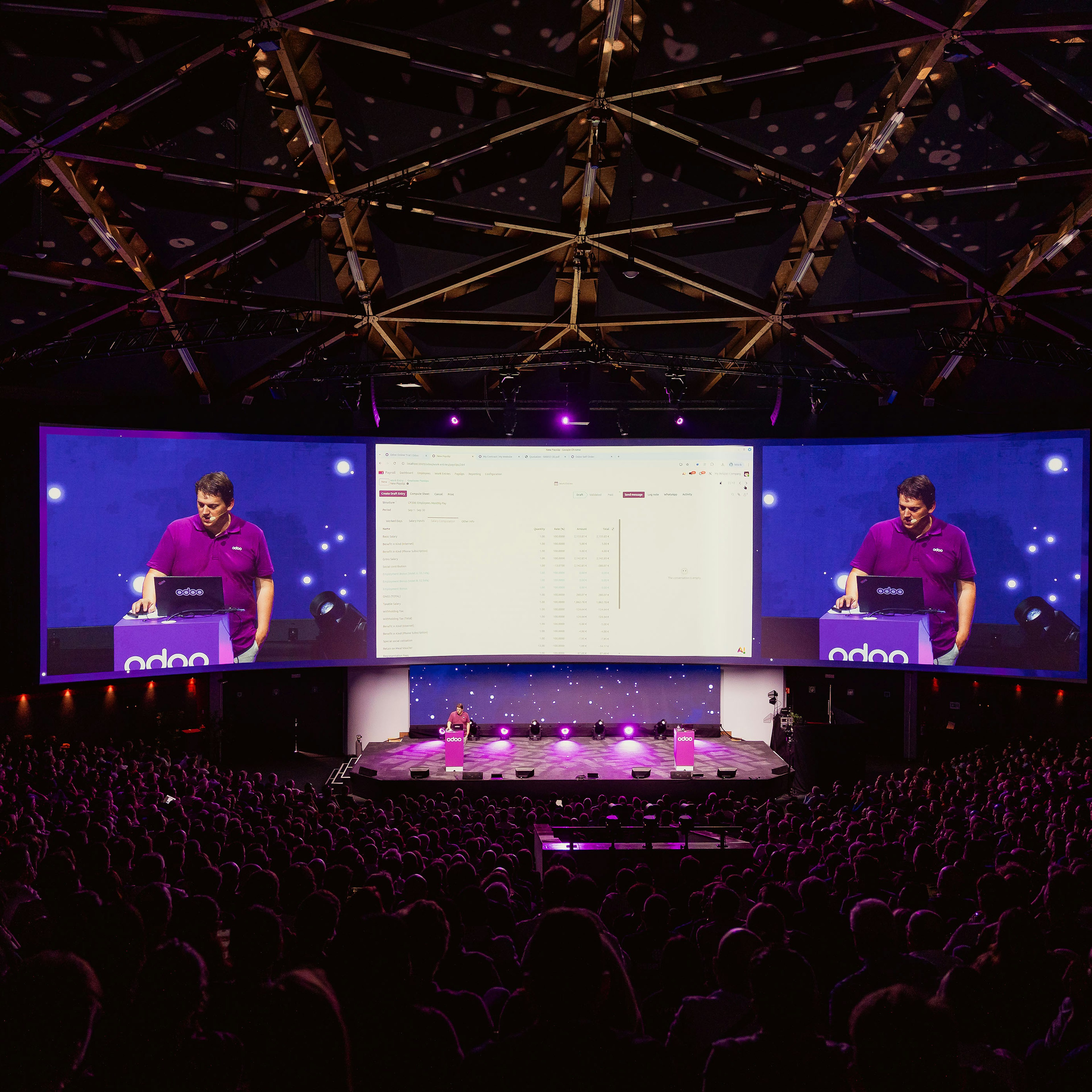 Packed Odoo keynote with speaker on giant screens