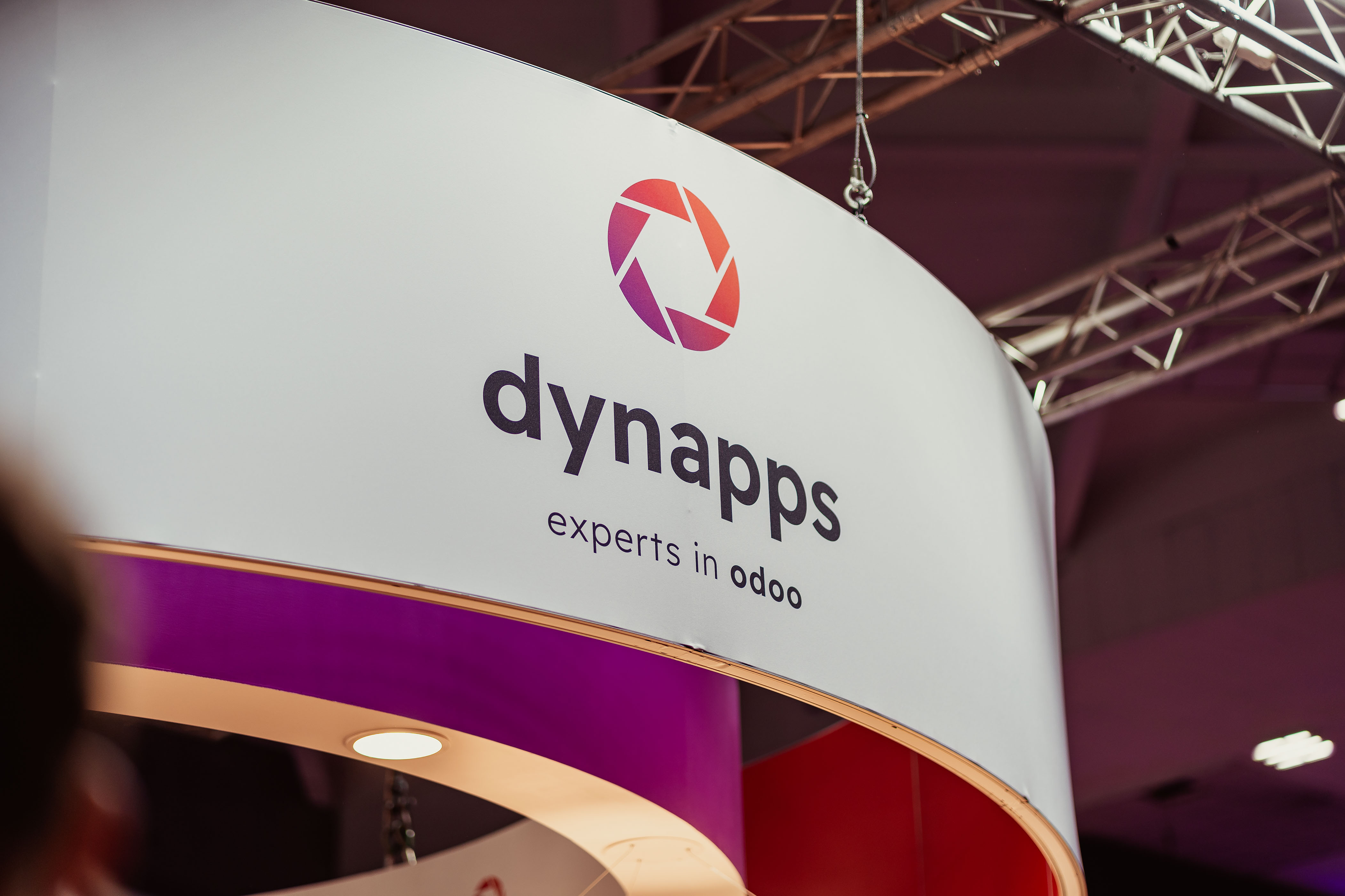 Close-up of the round Dynapps booth signage at a fair