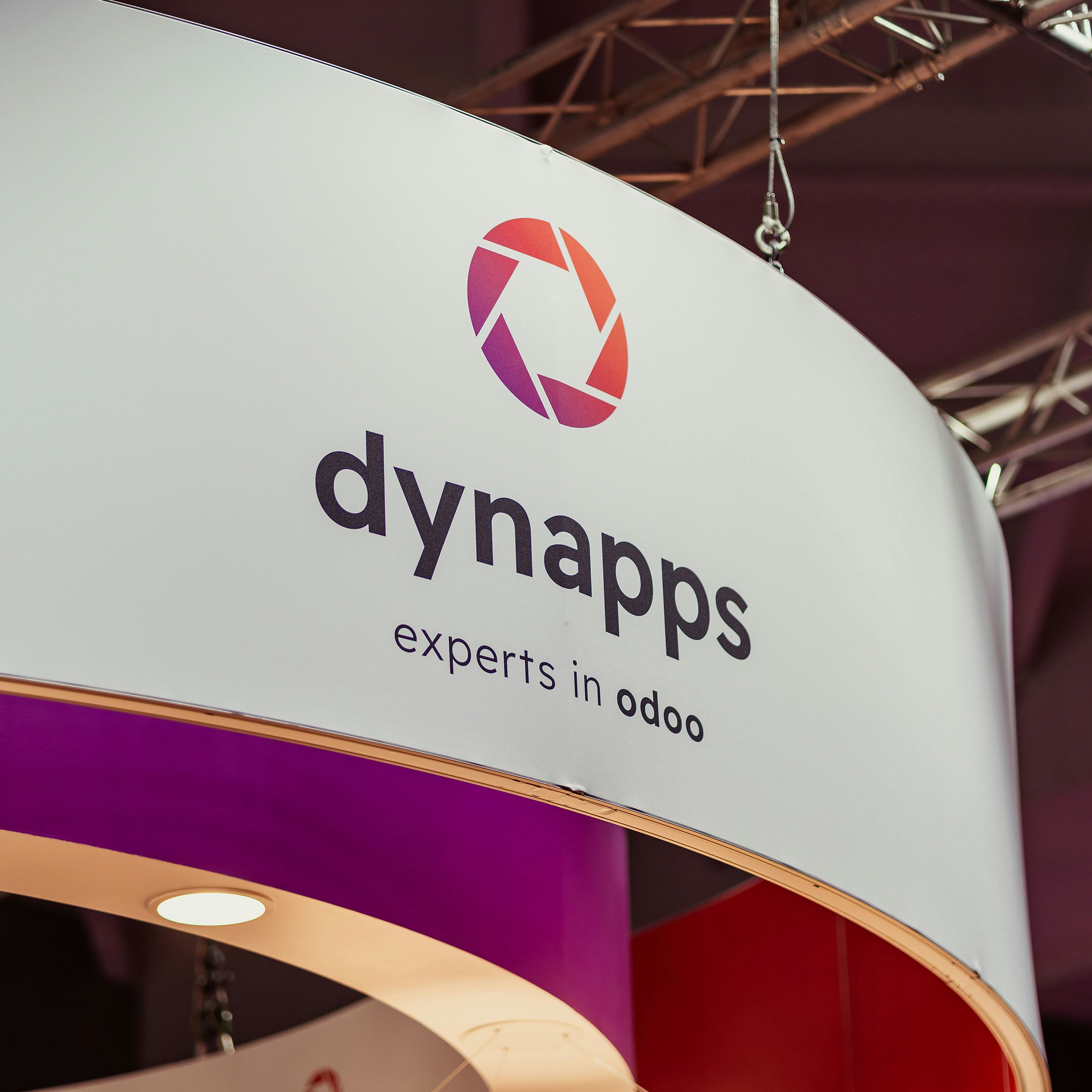 Close-up of the round Dynapps booth signage at a fair