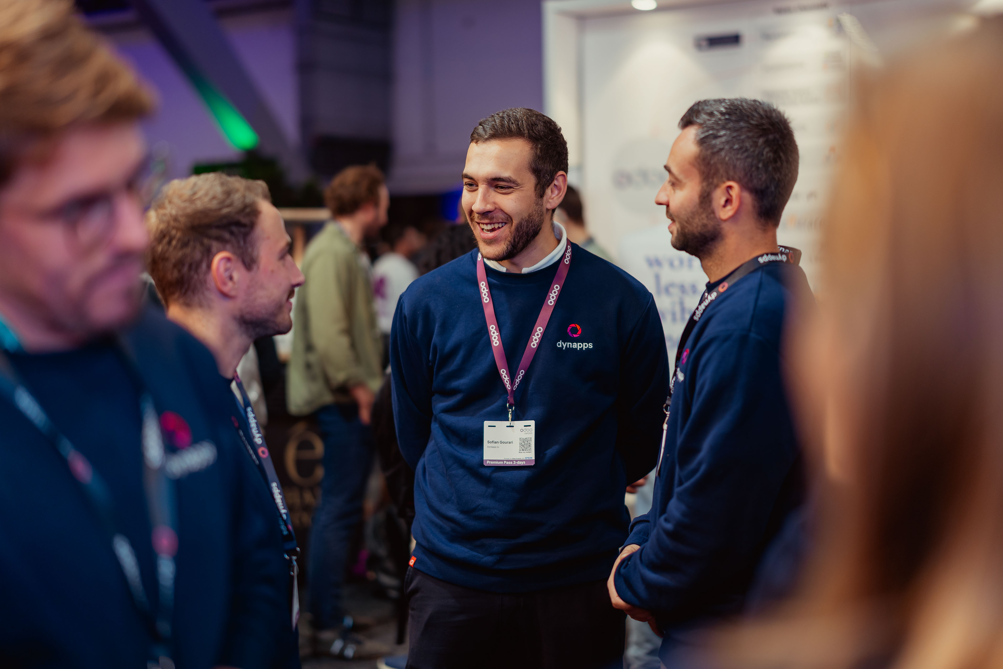 Dynapps team members laughing together at a trade event