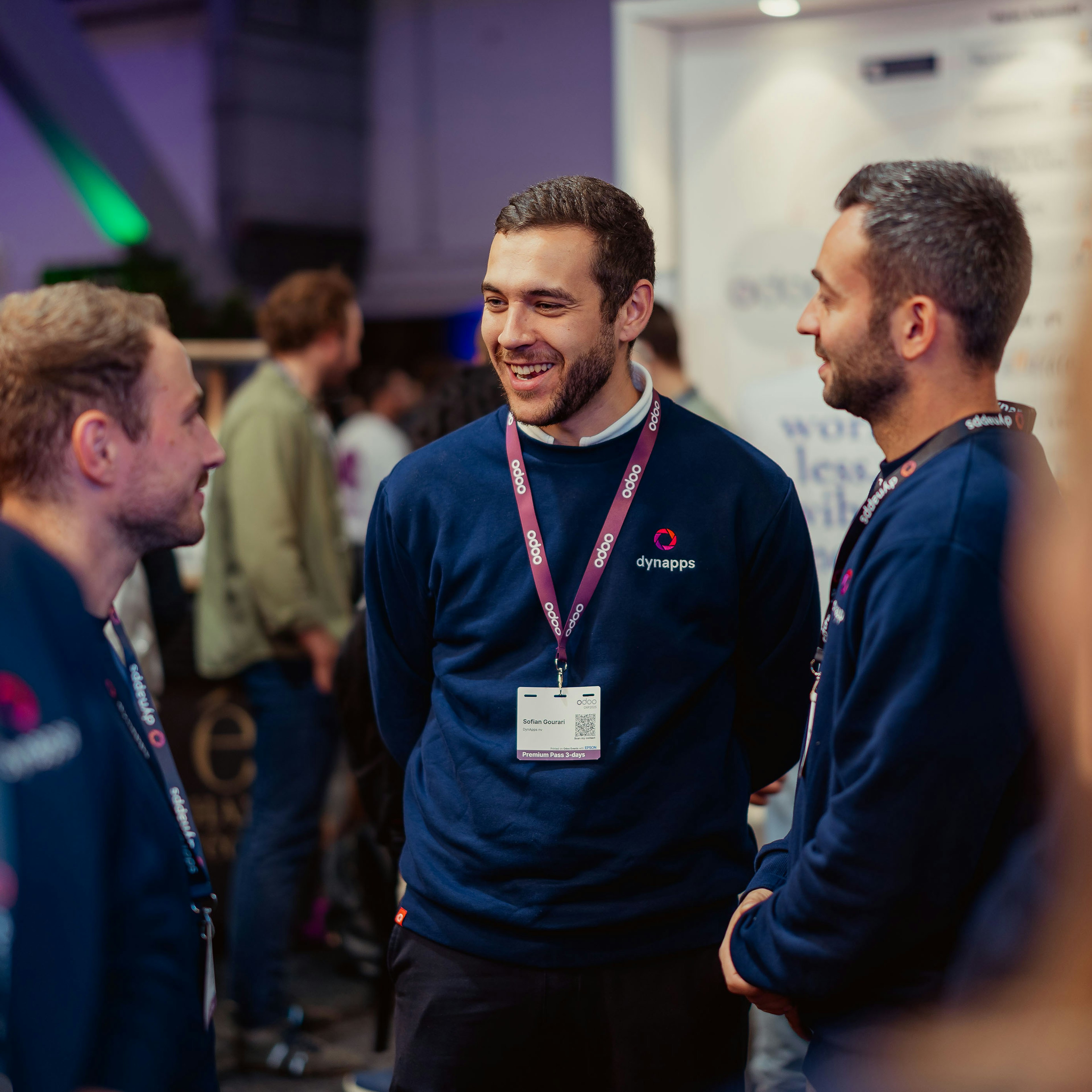 Dynapps team members laughing together at a trade event