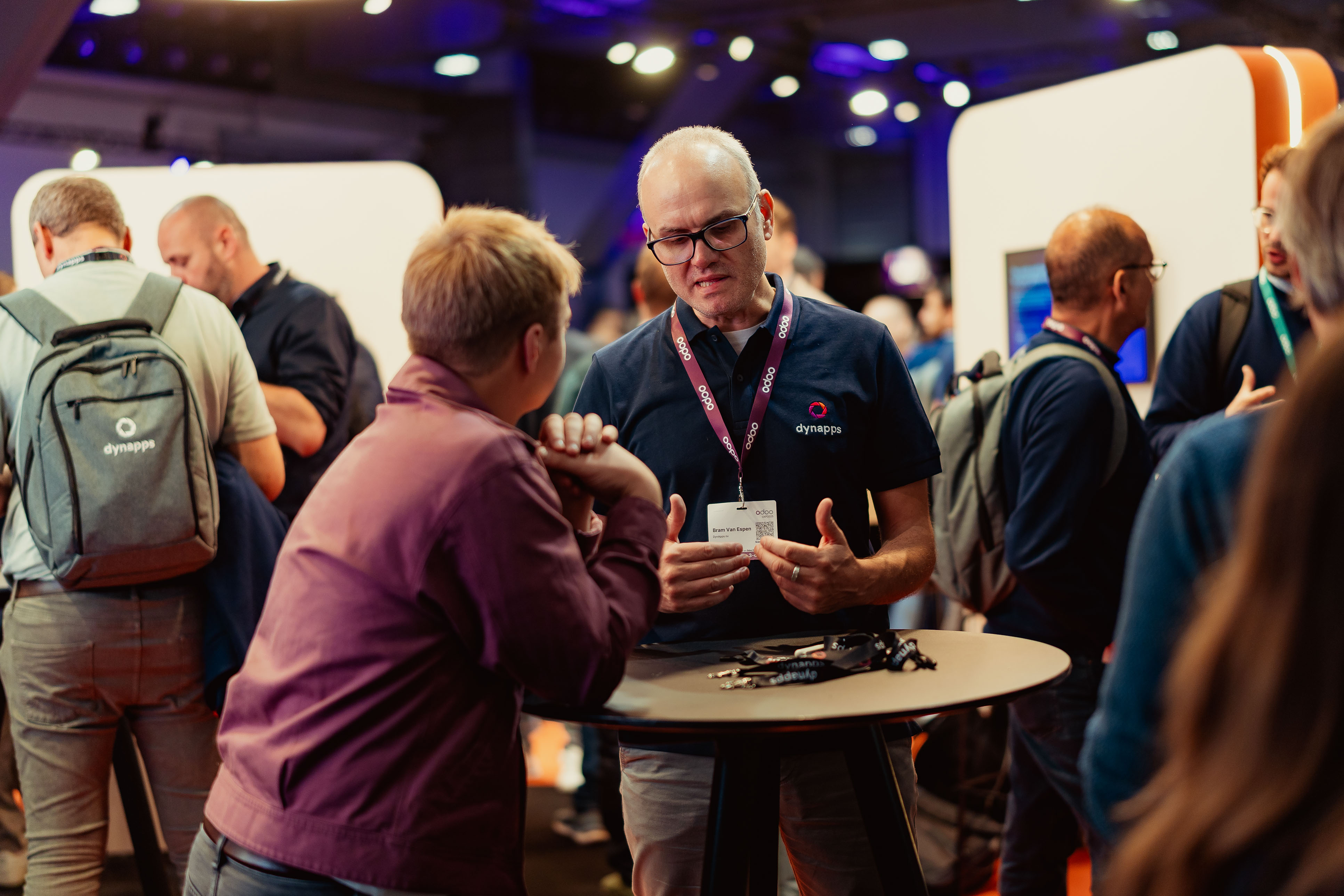 Dynapps consultant in conversation at a crowded event stand